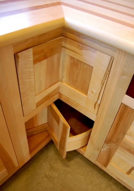 Lazy susan inspired corner cabinets take advantage of otherwise lost space in this Upstate NY kitchen.