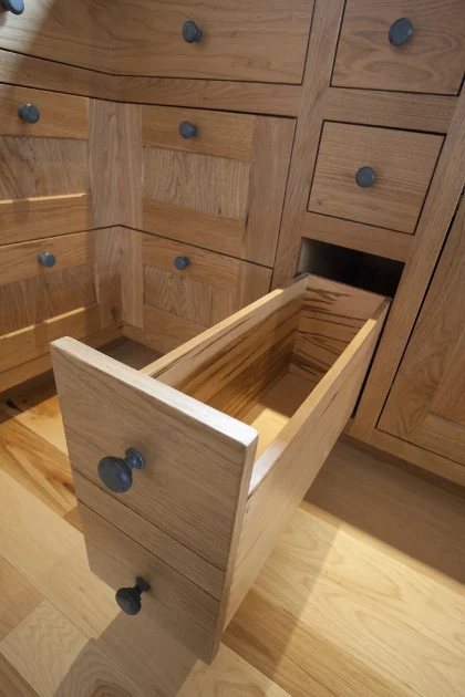 Dan and Beth's custom kitchen cabinetry is crafted from Butternut and rests on hickory flooring.