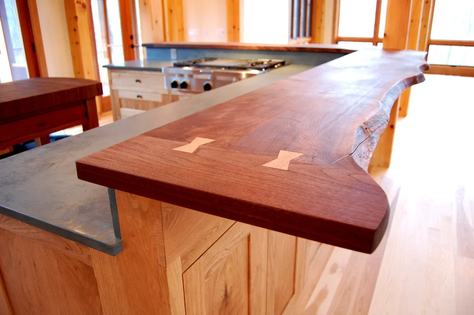 This live edge Walnut top feautres Butternut butterfly joints and tops custom Butternut cabinetry for a kitchen in Mendon, NY.