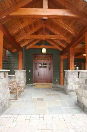 Timber frame entry porch with custom door.