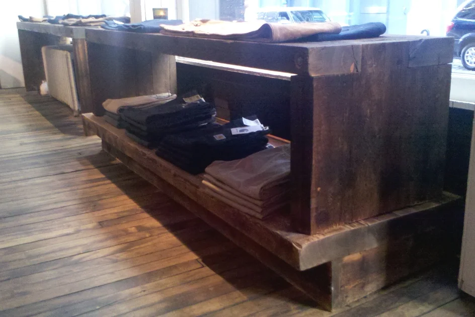 Crafted using hemlock planks reclaimed from the Essex County Jail complex, this fixture melds with the industrial chic look of a NYC retail store. F19