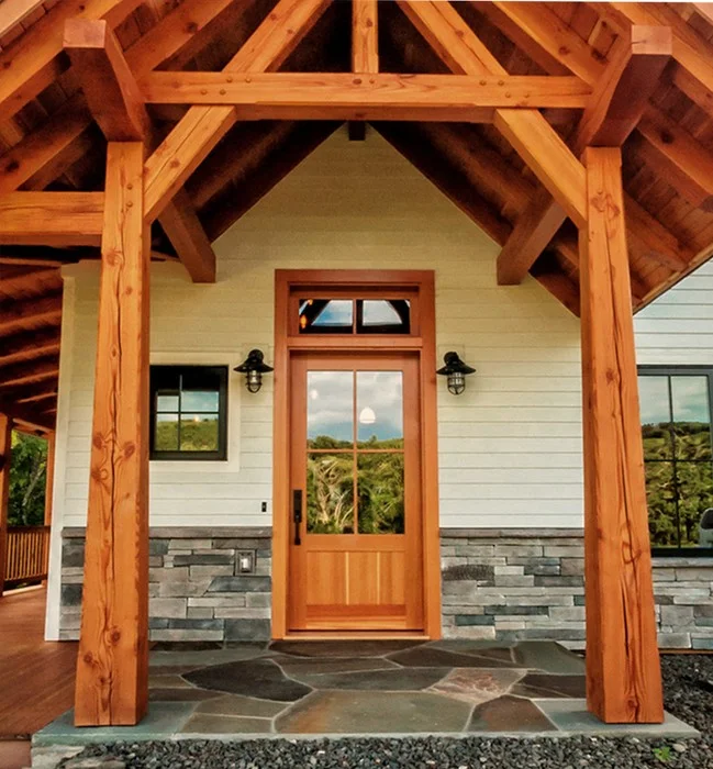 The entry to this family home greets visitors with a custom Douglas fir door which accommodates the needs of a handicapped child while allowing abundant light into the home. D4