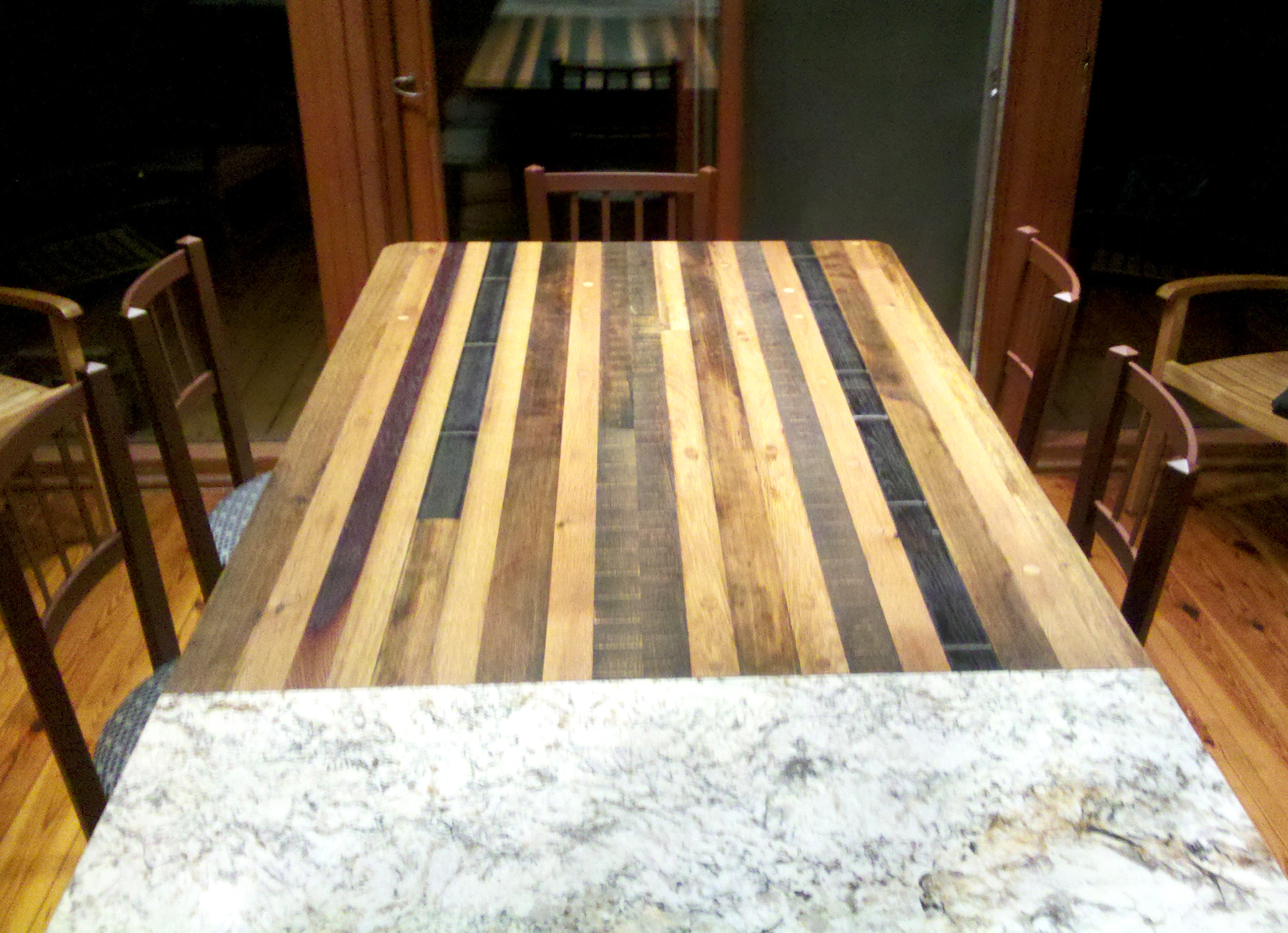 Old French white oak and domestic barrel/vat stave were repurposed into a dining table for Mathew's family meals.