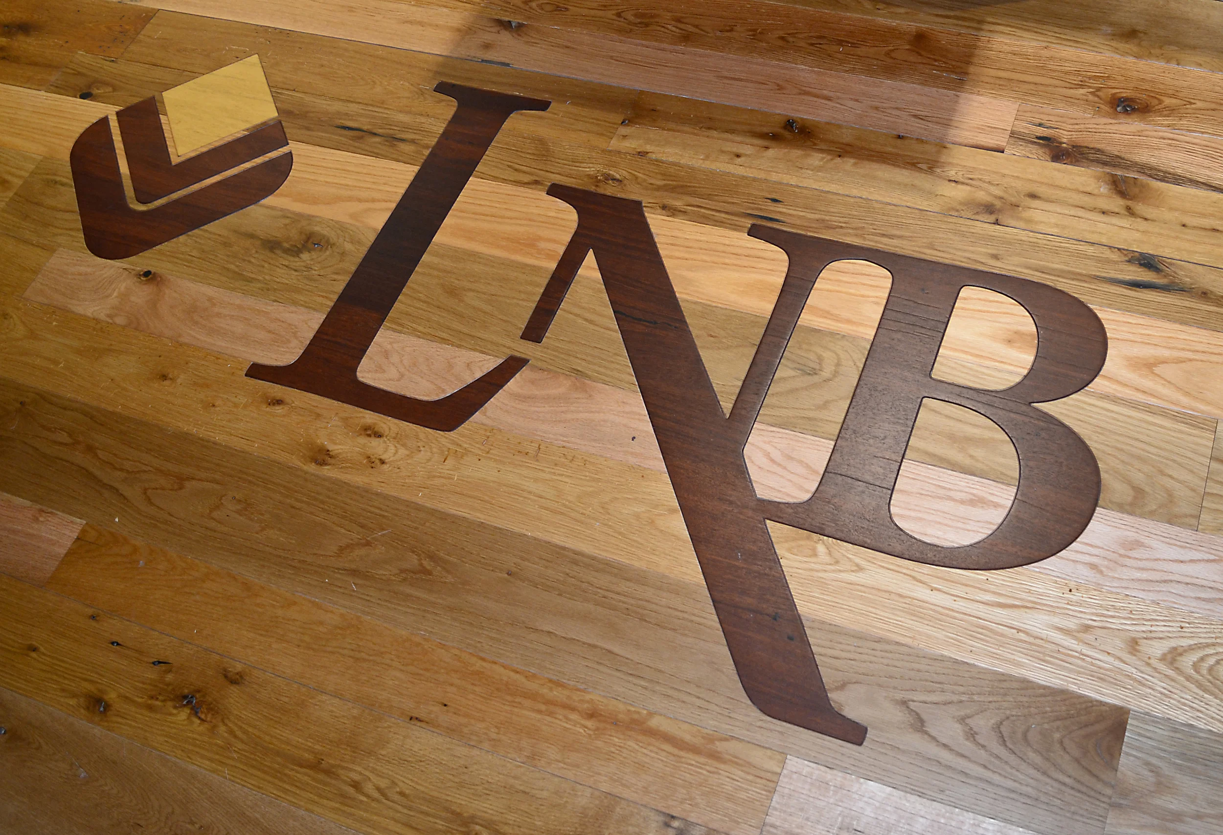 Lyons National Bank custom inlay blends seamlessly with the reclaimed American Gothic Oak flooring.