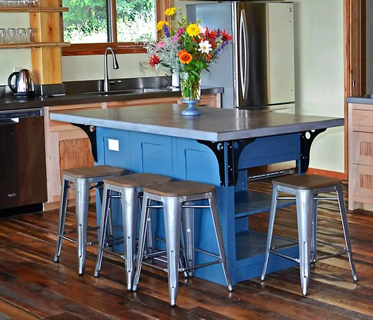 This blue island with a cement top lends a pop of color in a custom lake vacation home.