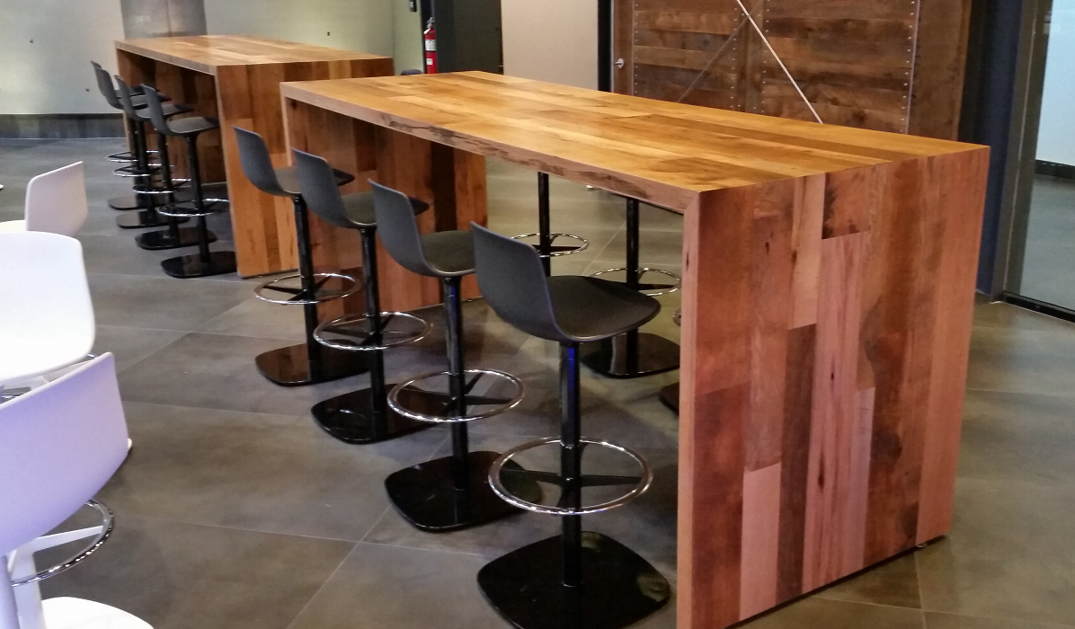 Communal tables crafted of reclaimed hardwoods for BankUnited in Florida.