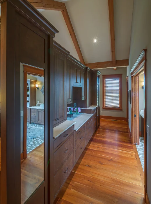 This stained cherry bedroom cabinetry is headboard and night stands on one face and dresser/vanity on the opposite face.