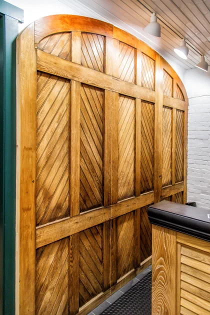 Detail of refinished and crafted door for spa reception feature wall