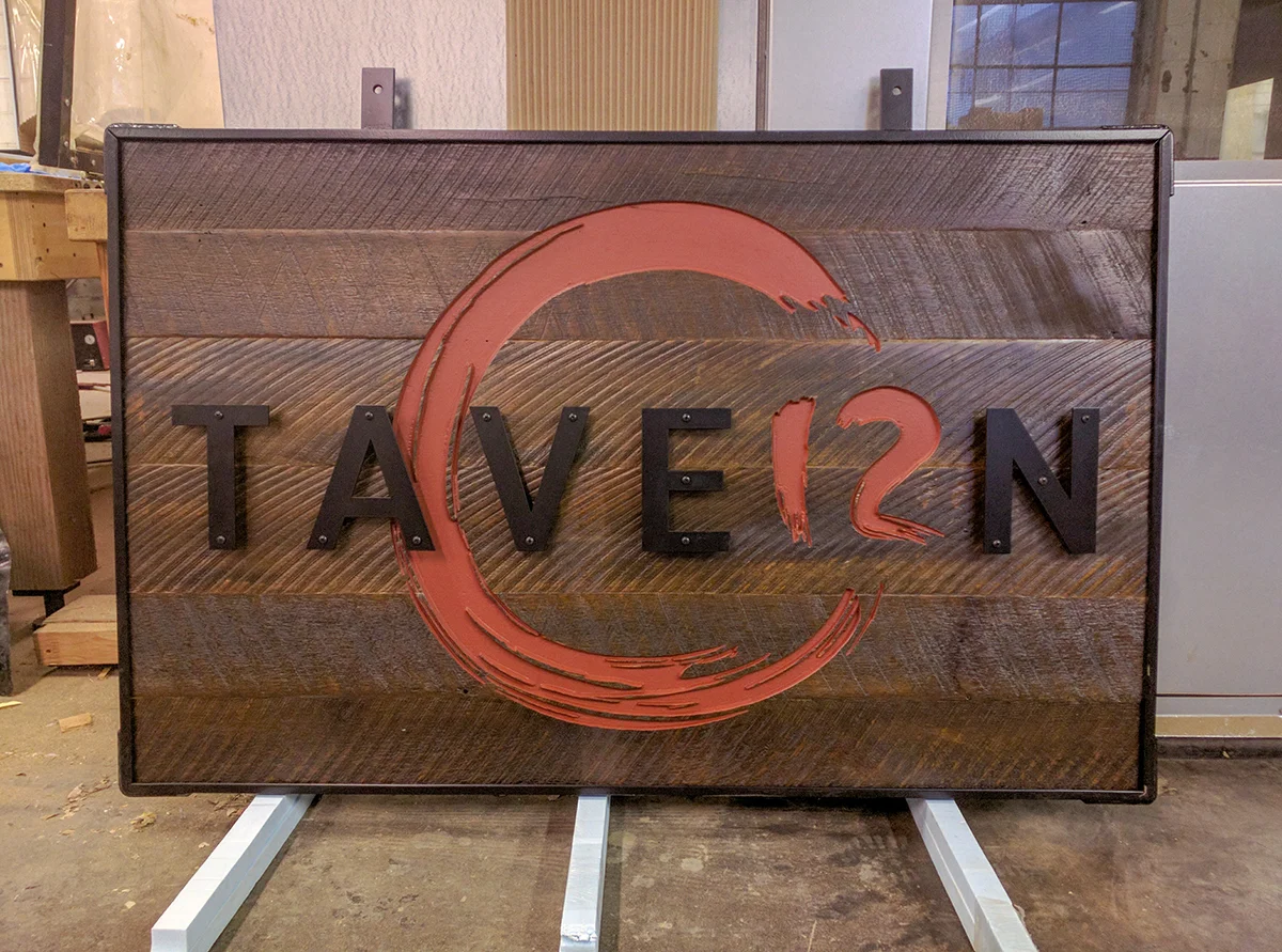 Reclaimed wood sign with custom metal work