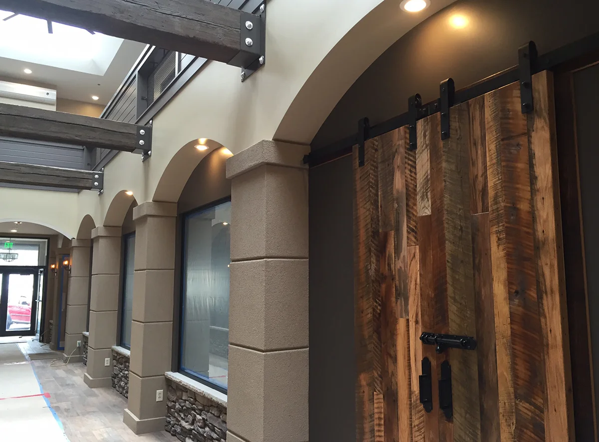 Flat track door with center opening and bolt lock. Wood is reclaimed mixed oak.
