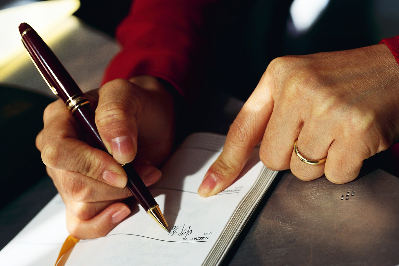Person writing in food journal - Ultimate Health Personal Trainer Sudio City/Toluca Lake, CA