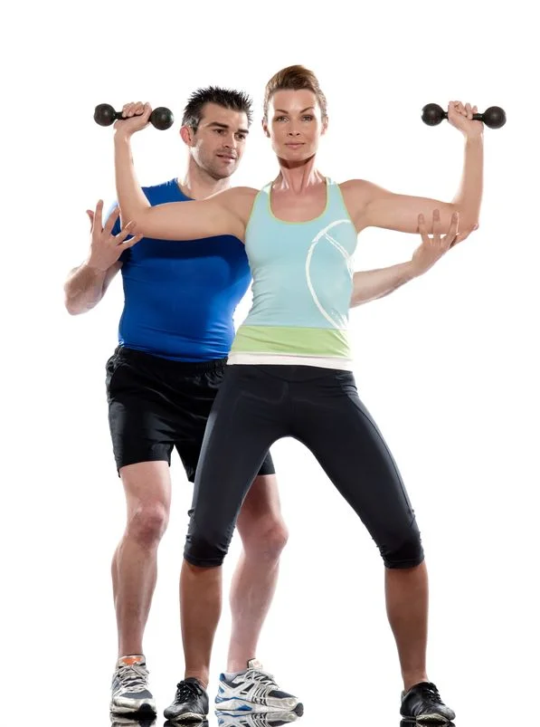 Male Trainer helping female client - Personal Trainer Studio City