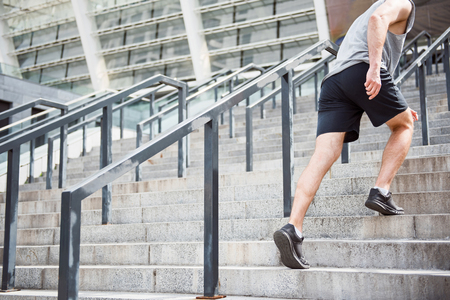 Man running up stairs in shorts