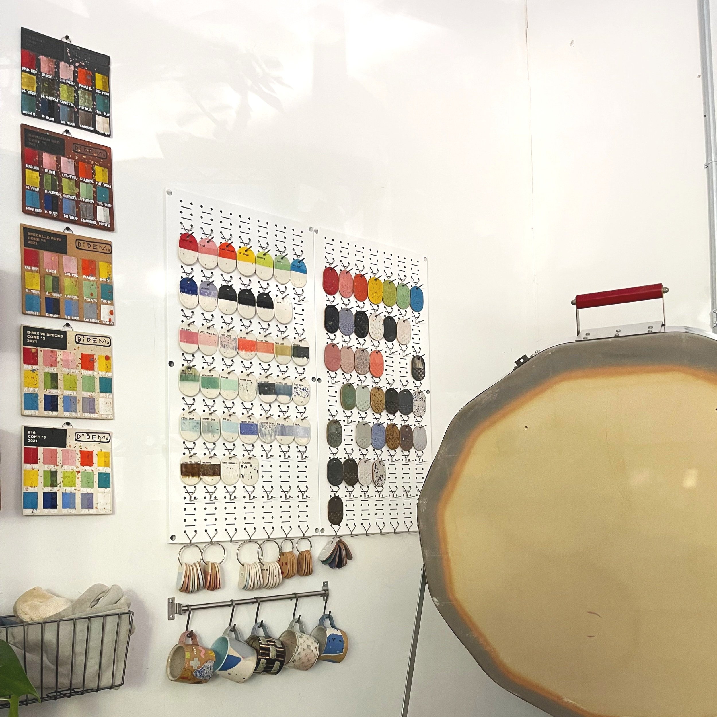  Above: Test tile boards to the left and individual test tiles on a metal pegboard.  Organized into rainbow formation, bc duh! 