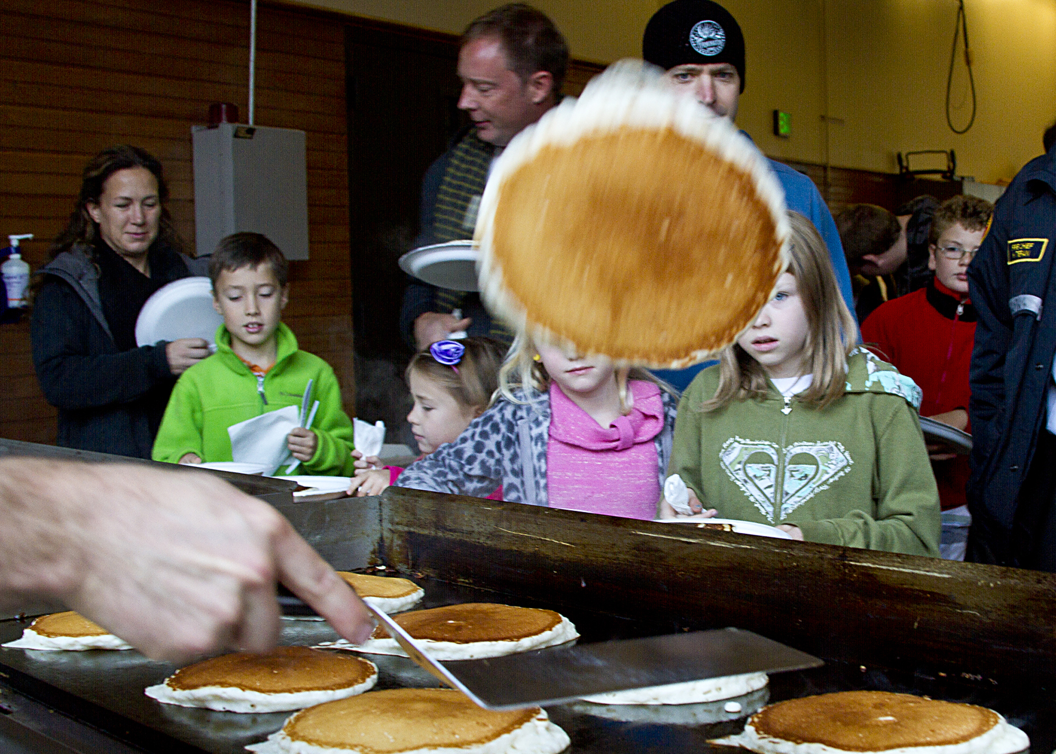   Firefighter Kyle Moerke does some fancy cooking tricks at the 17th annual Bainbridge Island Volunteer Firefighters Association pancake breakfast.&nbsp;  