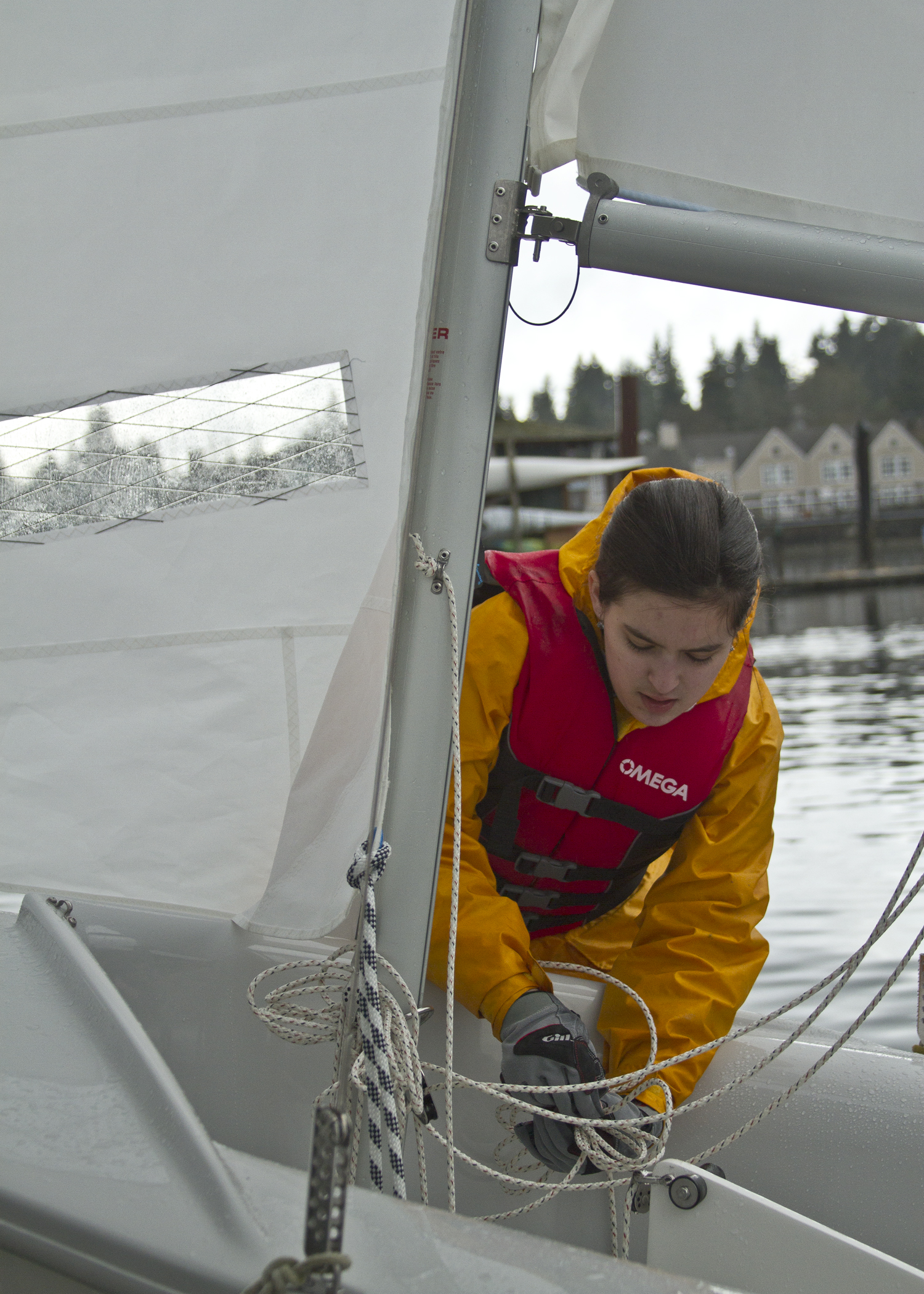  Bainbridge High School freshman sailor Diana Curtis prepares her boat to be put into the water during the team's second practice session of the 2013 season.&nbsp; 