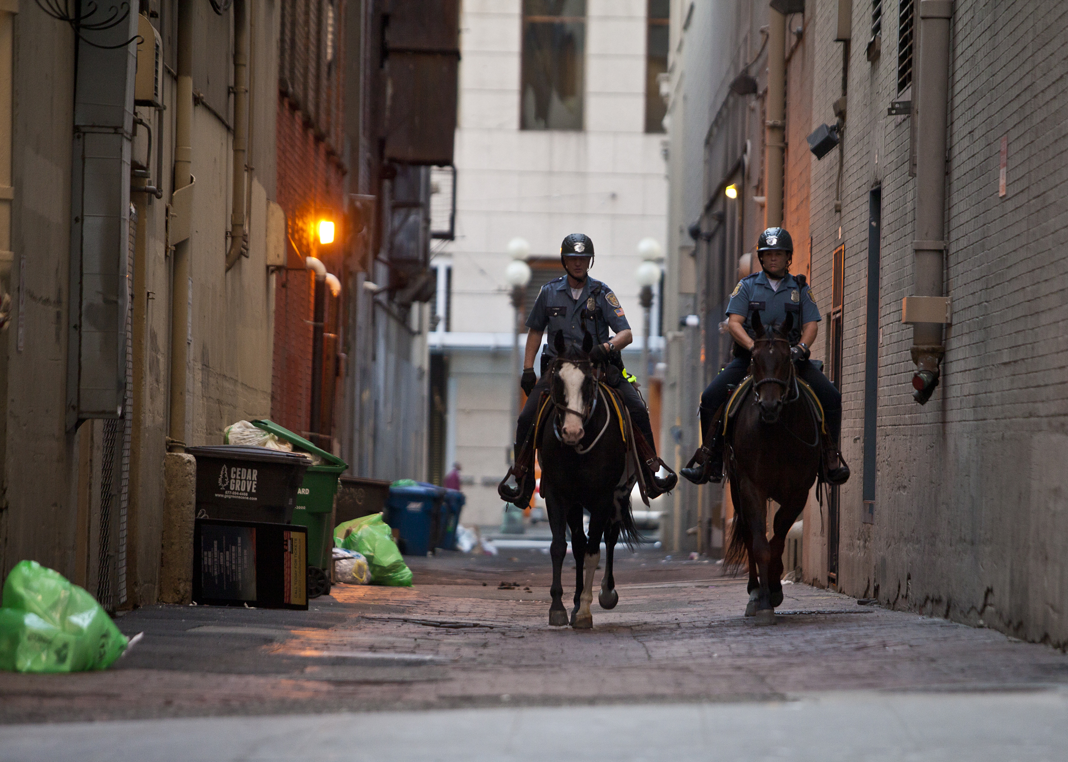 Two Seattle Police Officers patrol an alley near the established route for the 2014 Torchlight Parade. 
