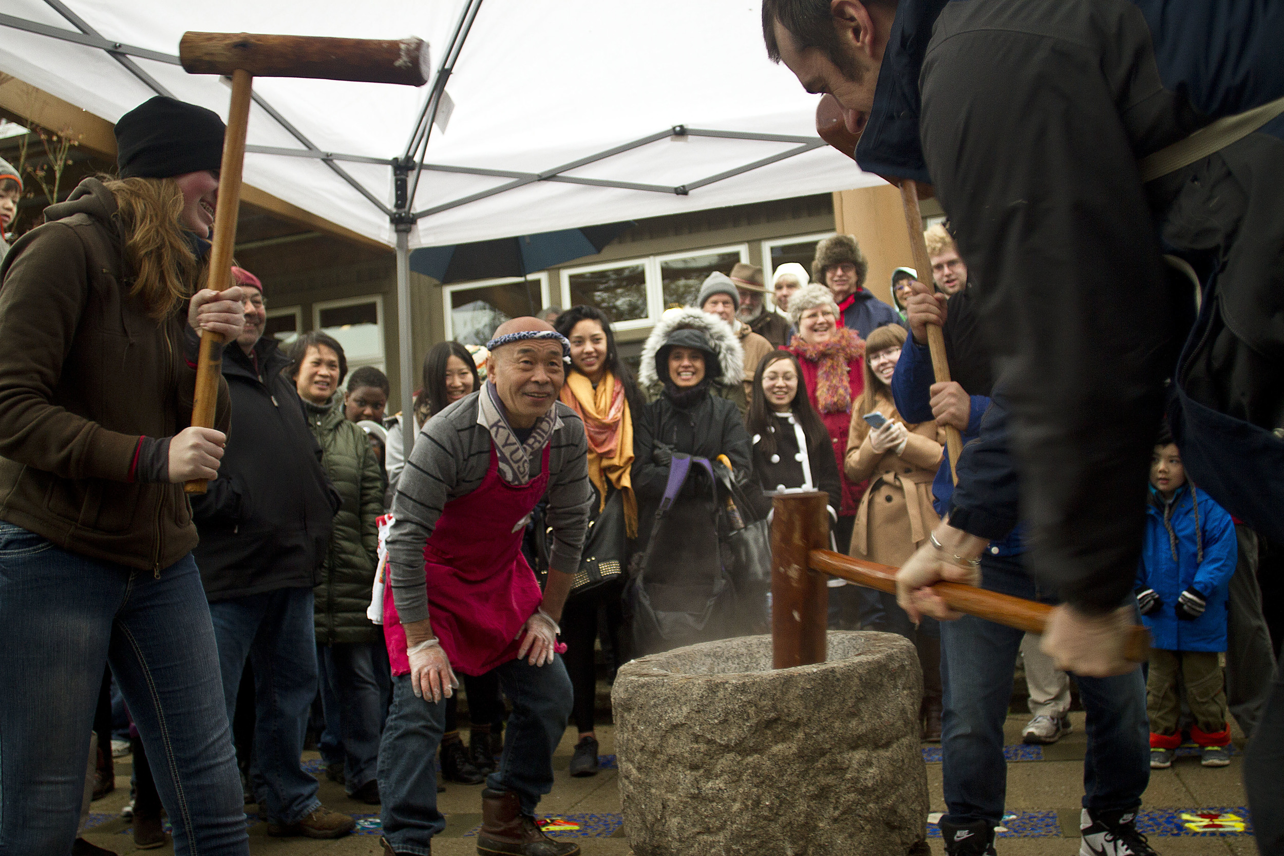   Shoichi Sugiyama, a volunteer with the Bainbridge Island Japanese American Community and staple figure at the island’s annual New Year’s mochi tsuki event, watches as the guests he instructed take their turn pounding the steamed rice with large woo