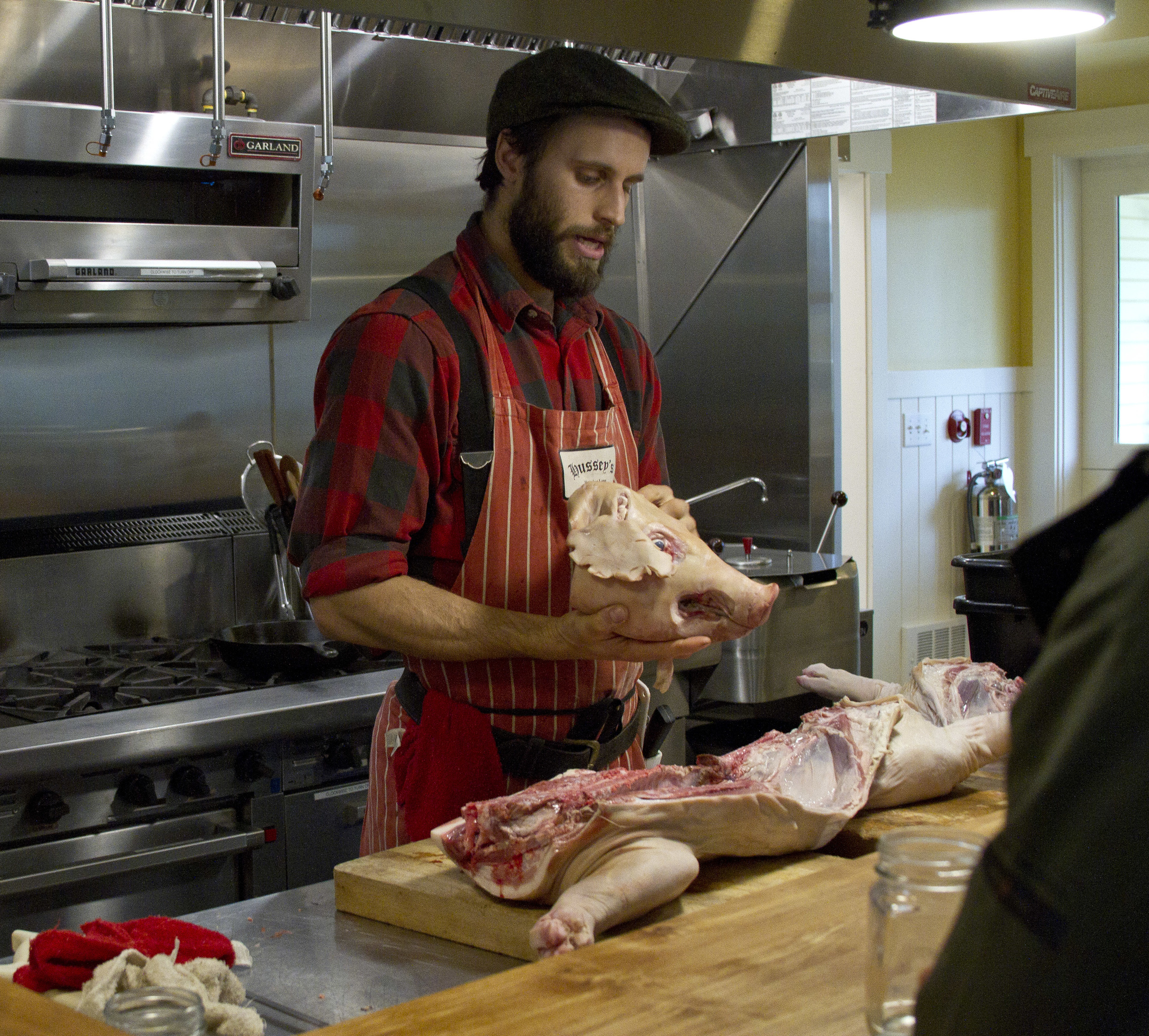  Brandon Sheard, of Farmstead Meatsmith, leads a whole hog butchery and curing workshops at Heyday Farm. 