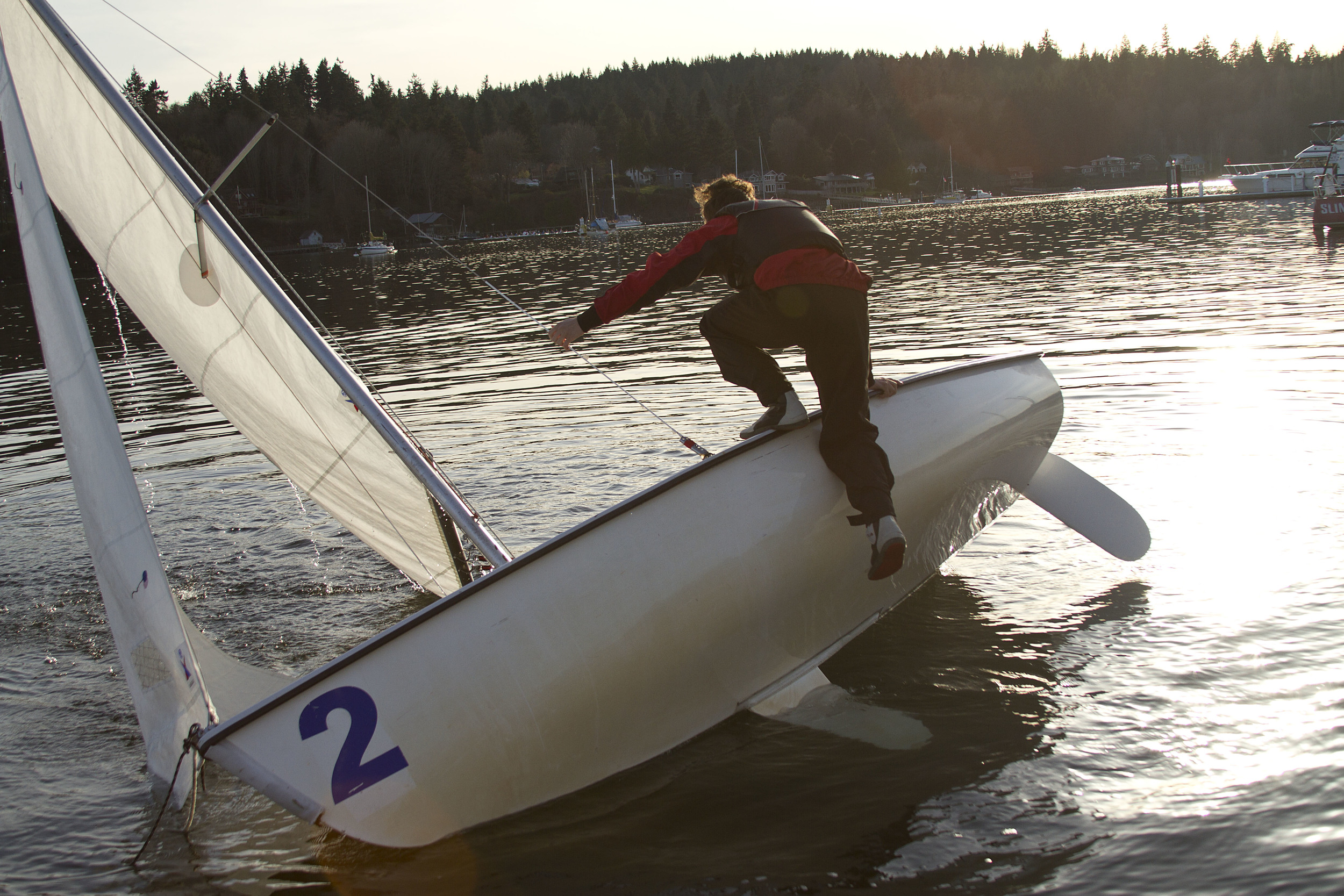 Students on the Bainbridge High School sailing team struggled through capsize drills during the initial days of practice on the water, a chilly — but necessary — early season requirement for competition. 