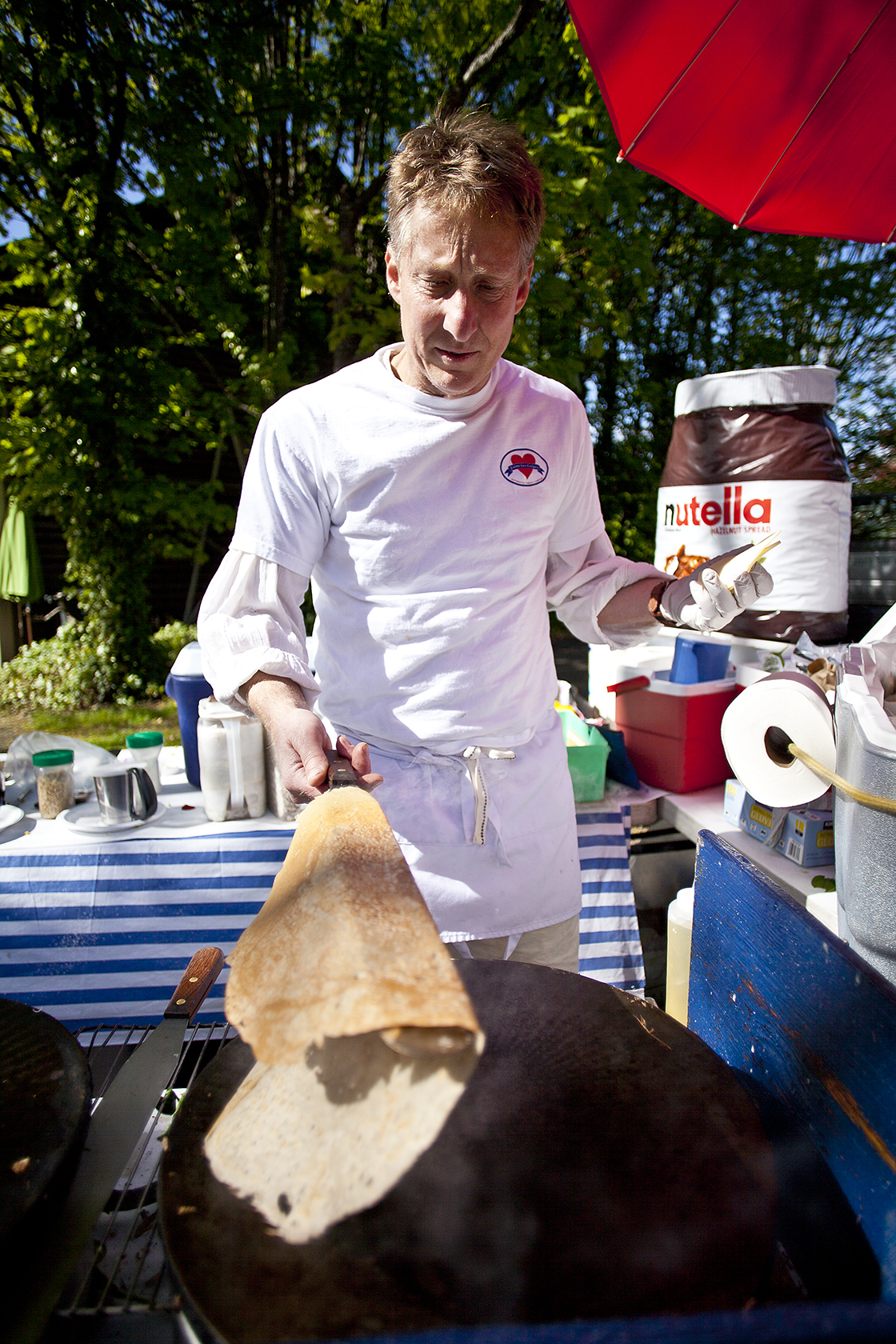 J’aime Les Crepes owner Paul Pluska cooks&nbsp;for visitors to the Bainbridge Island farmers market outside of his new Madrone Lane shop location prior to its grand opening.&nbsp; 