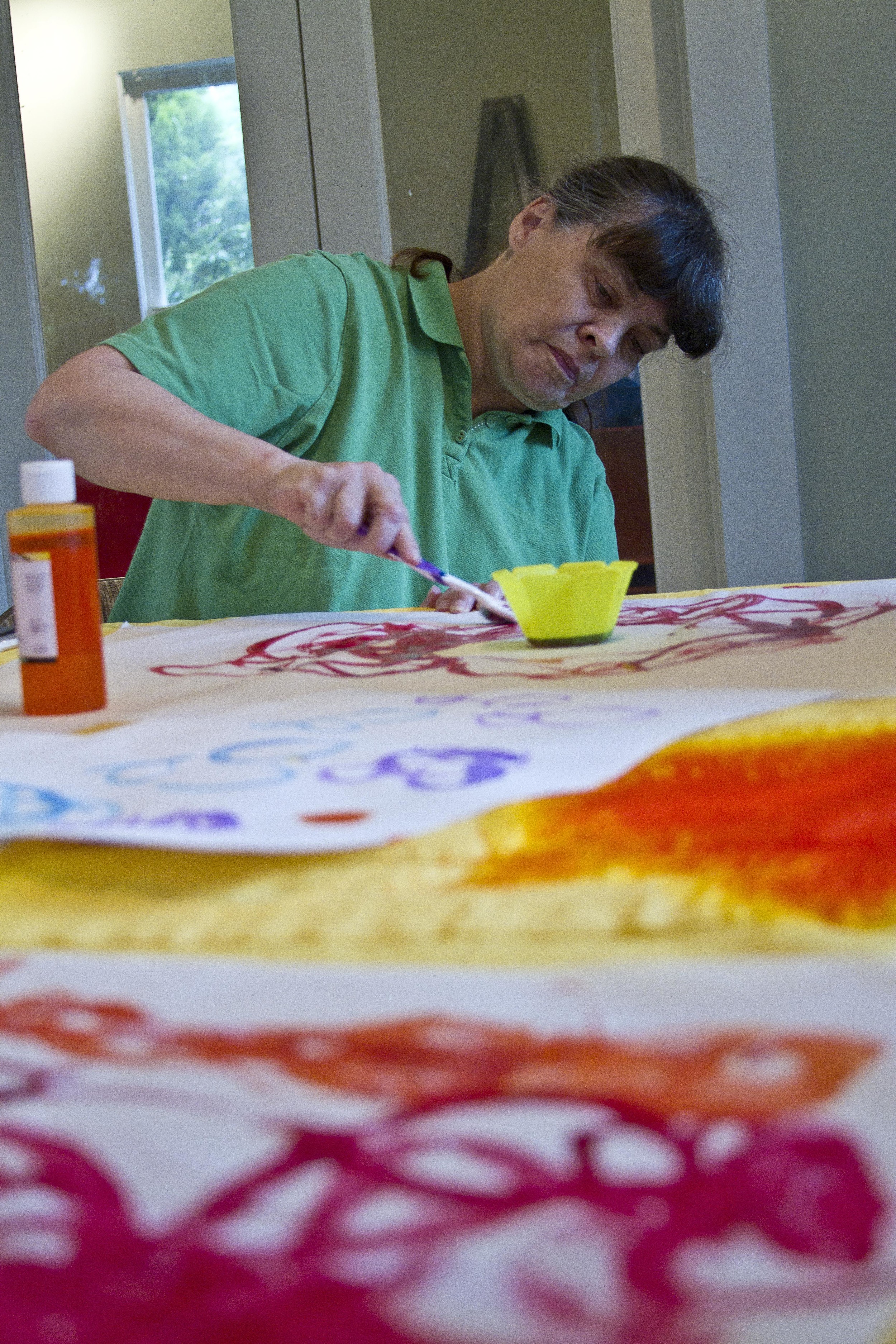  Bainbridge Island Special Needs Foundation client&nbsp;Darien Hellmuth paints during arts and crafts time.&nbsp; 