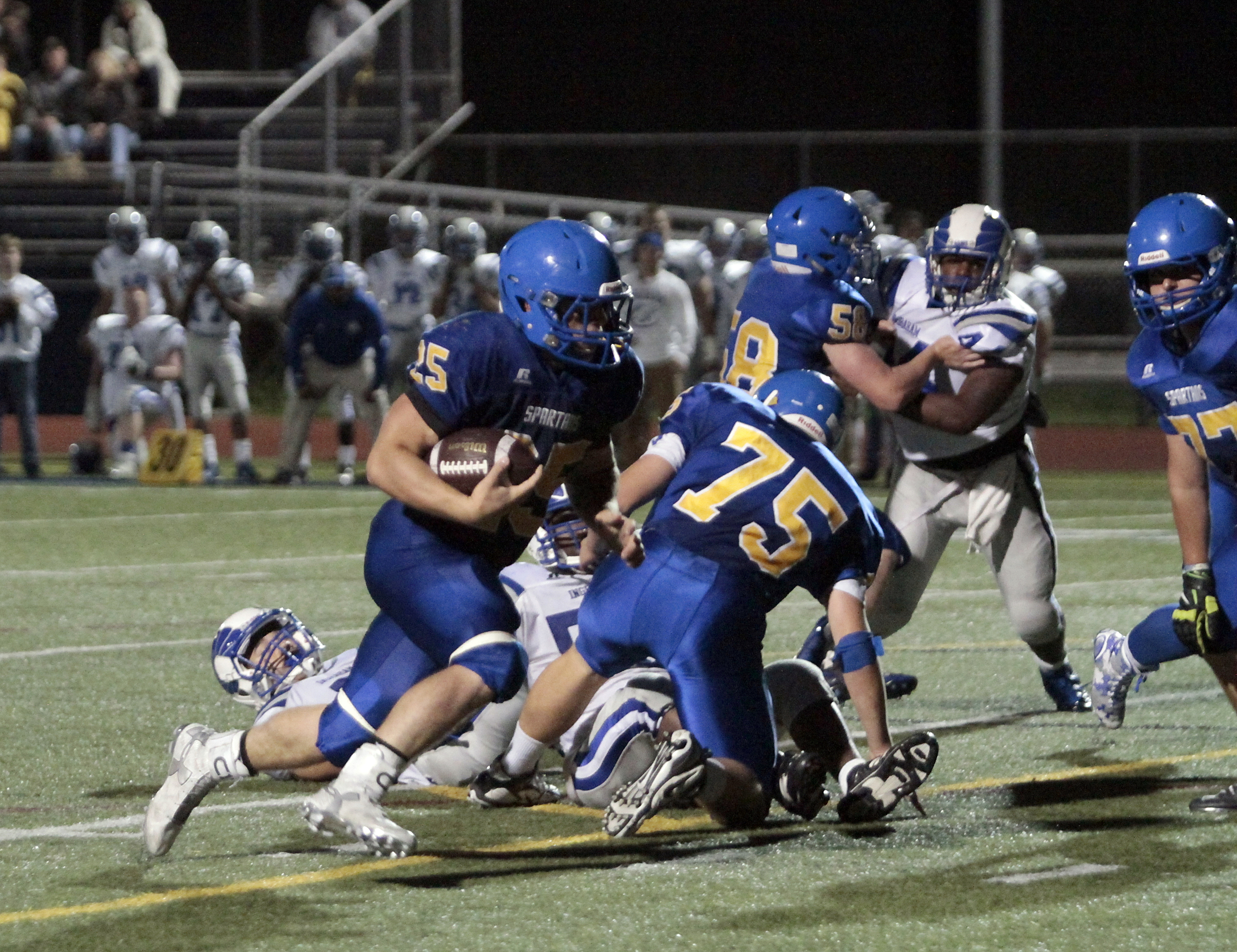  Bainbridge running back/linebacker Sam Wysong plows through the line at home against Ingraham. The senior Spartan gave a stellar early season performance, managing two touchdowns, 23 for 120 yards rushing and one reception for 23 yards.&nbsp;    