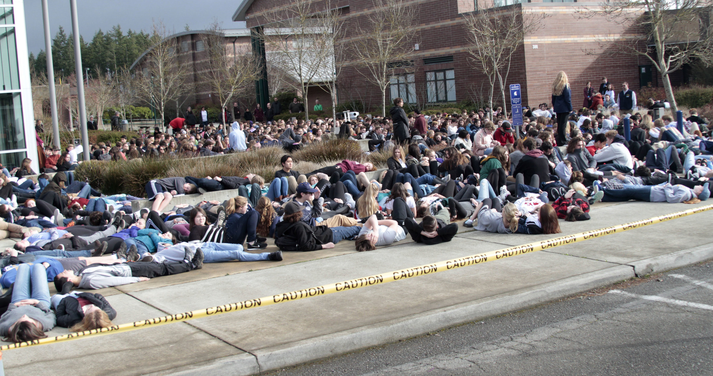  Hundreds of students from Bainbridge and Eagle Harbor high schools conduct a "die-in," as part of a symbolic walk out Wednesday, March 14, 2018, part of a protest by students around the nation calling for improved campus safety in the wake of regula