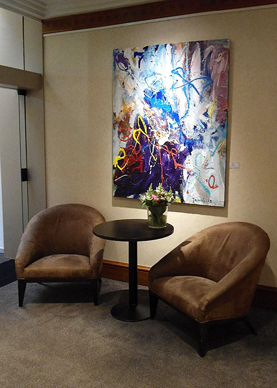 One painting above chairs
