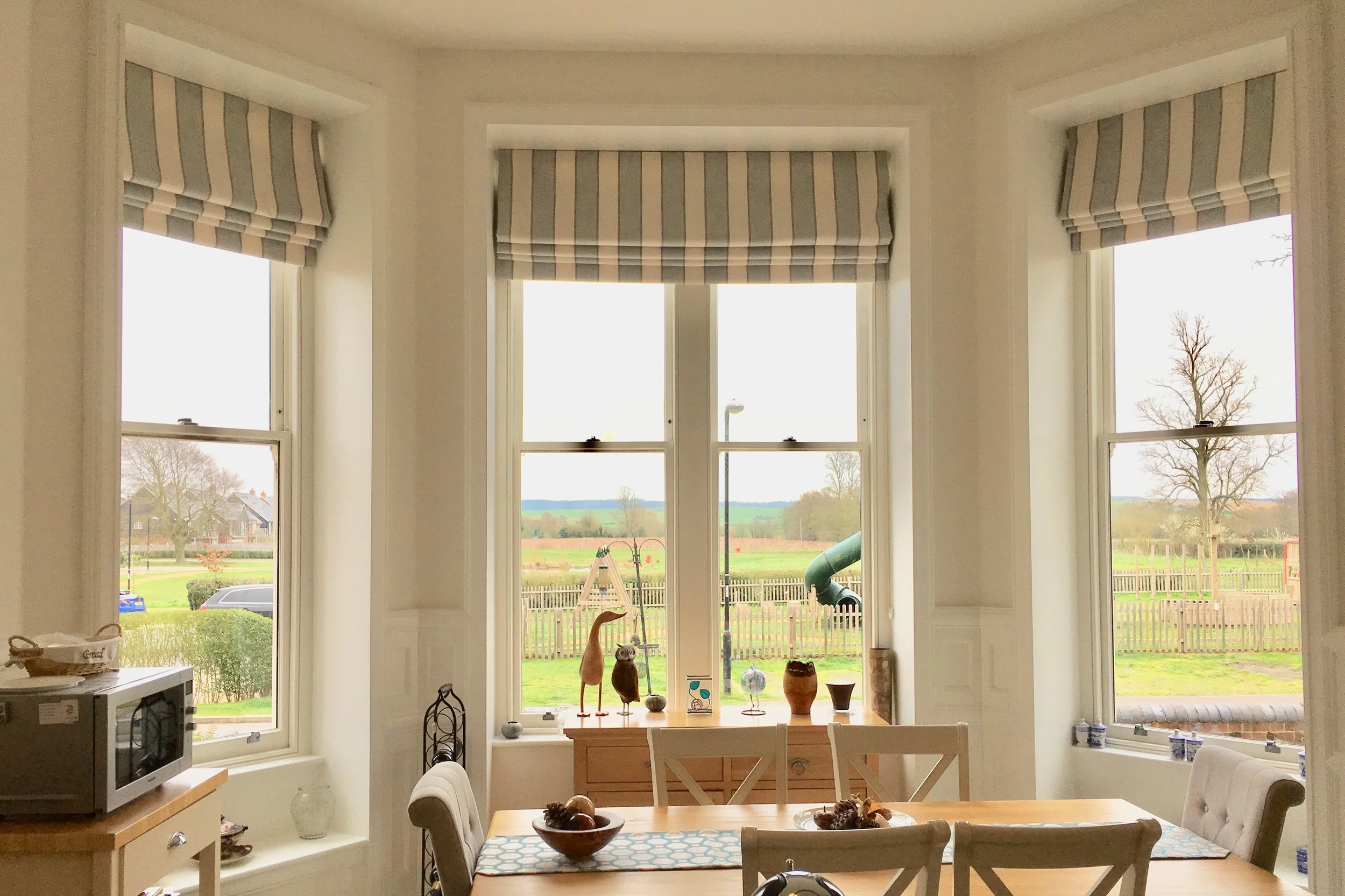 Roman Blinds set inside the recess keep this window looking fresh and uncluttered