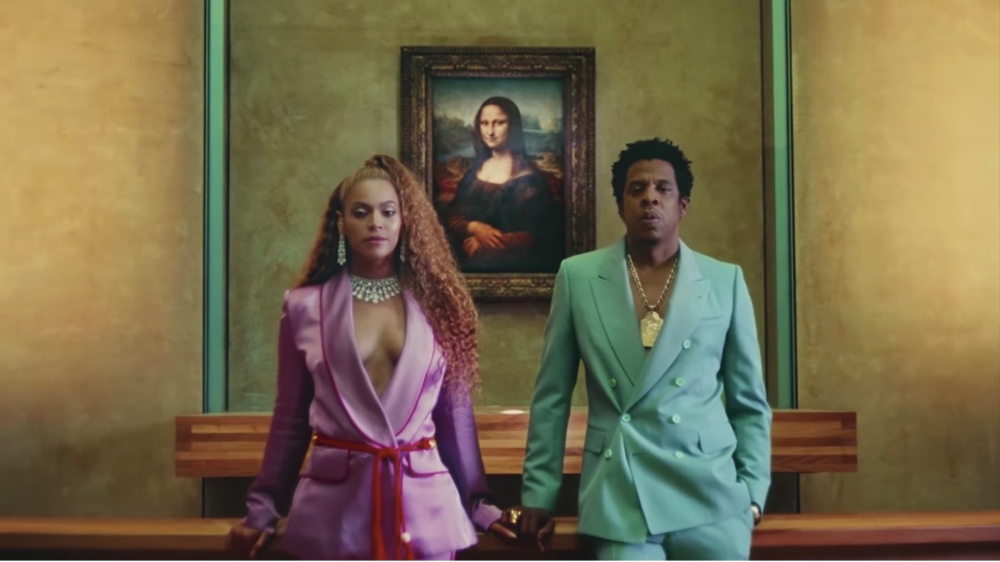 A still from "Apeshit," Beyoncé and Jay Z stand with the Mona Lisa.
