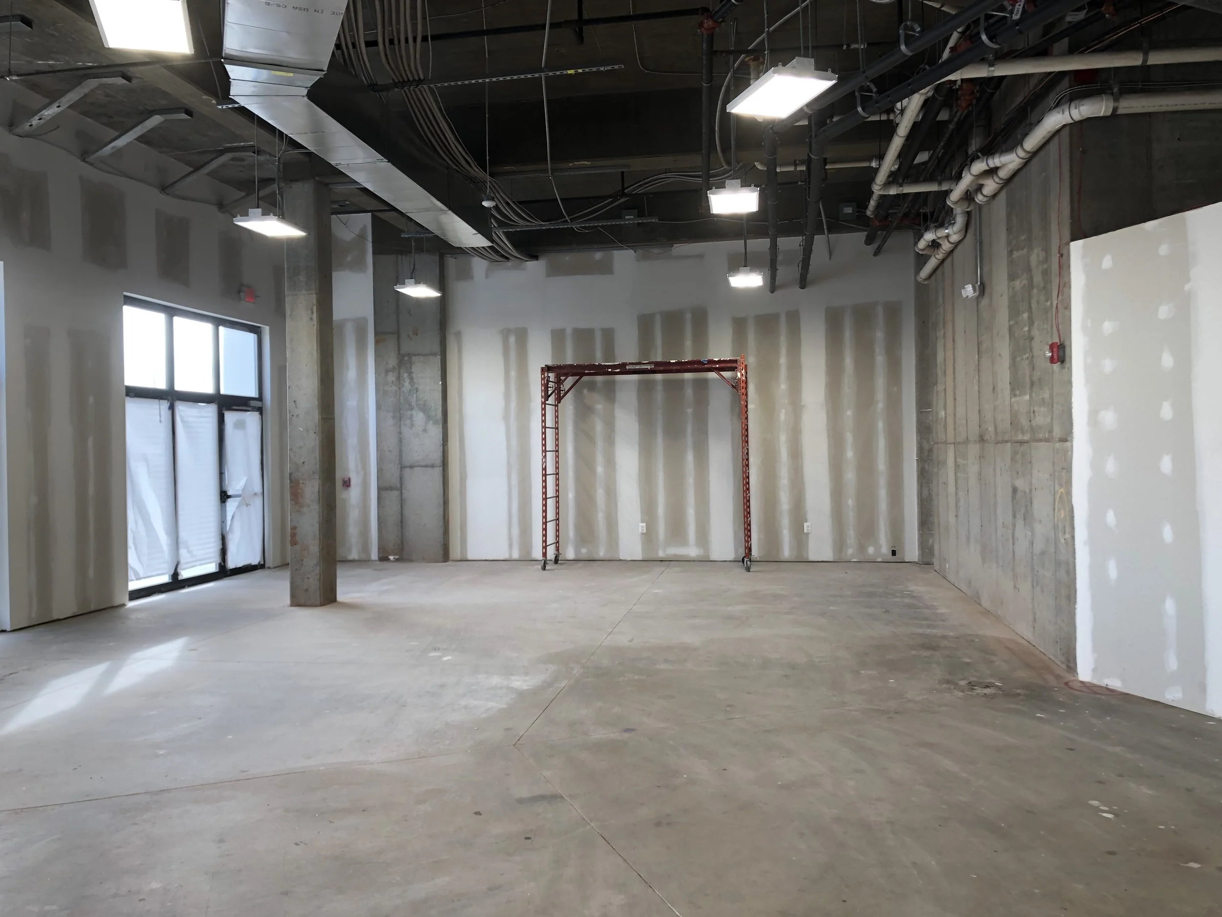 Painting - sanding the drywall and smoothing the concrete