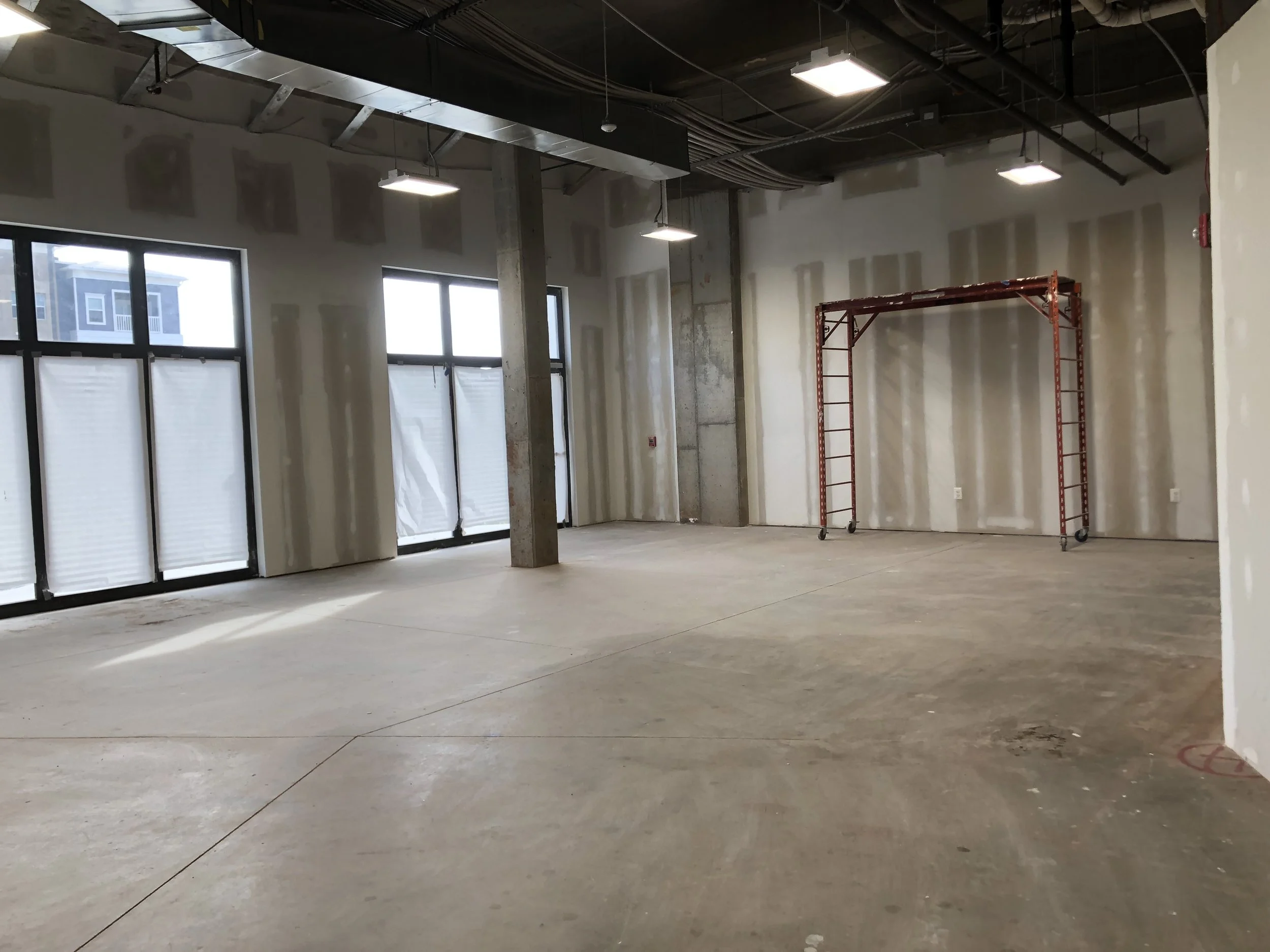 Painting - sanding the drywall and smoothing the concrete