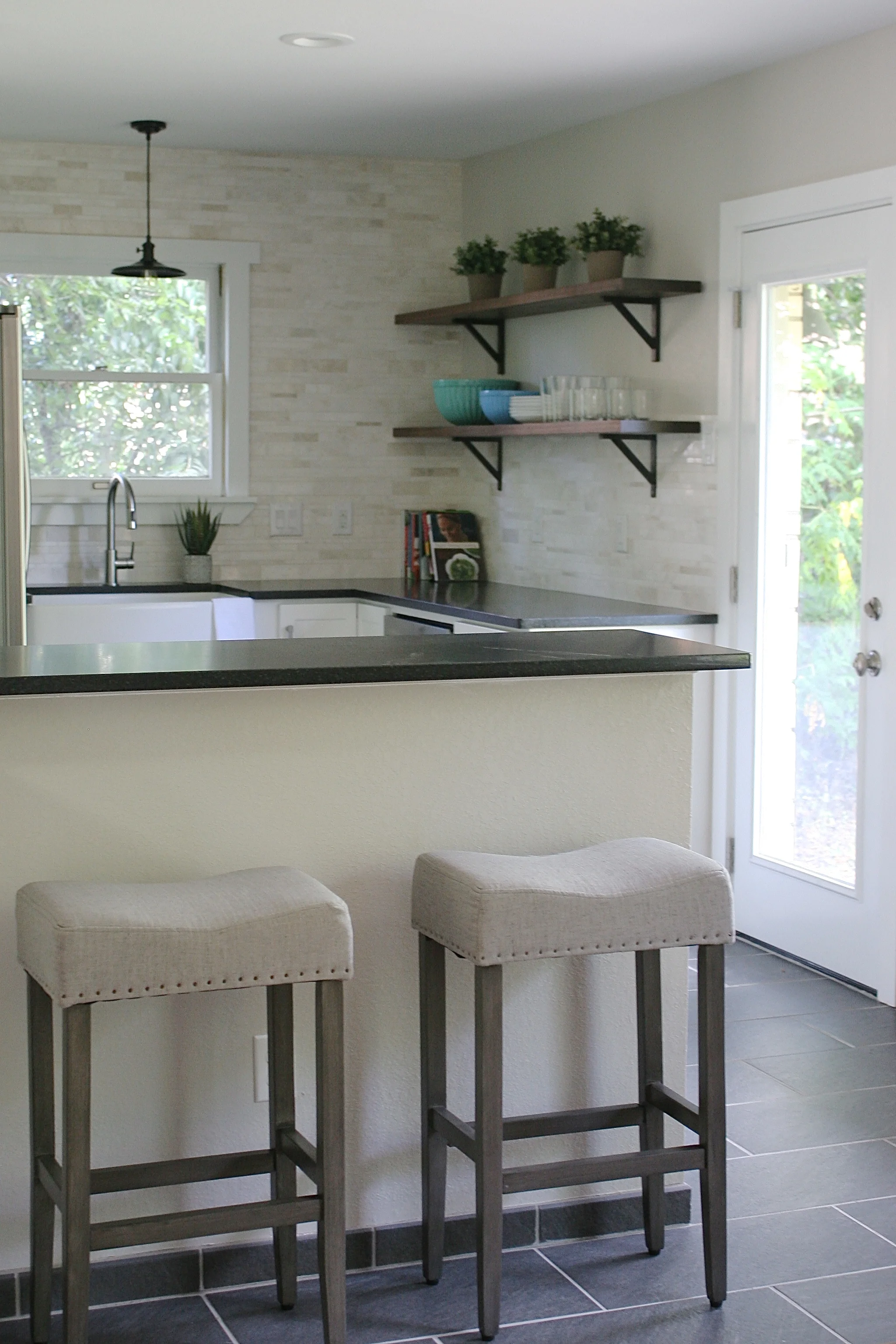 We added the single panel glass door to let in even more natural light. The flooring feels both vintage and modern, exactly the combination we were going for.