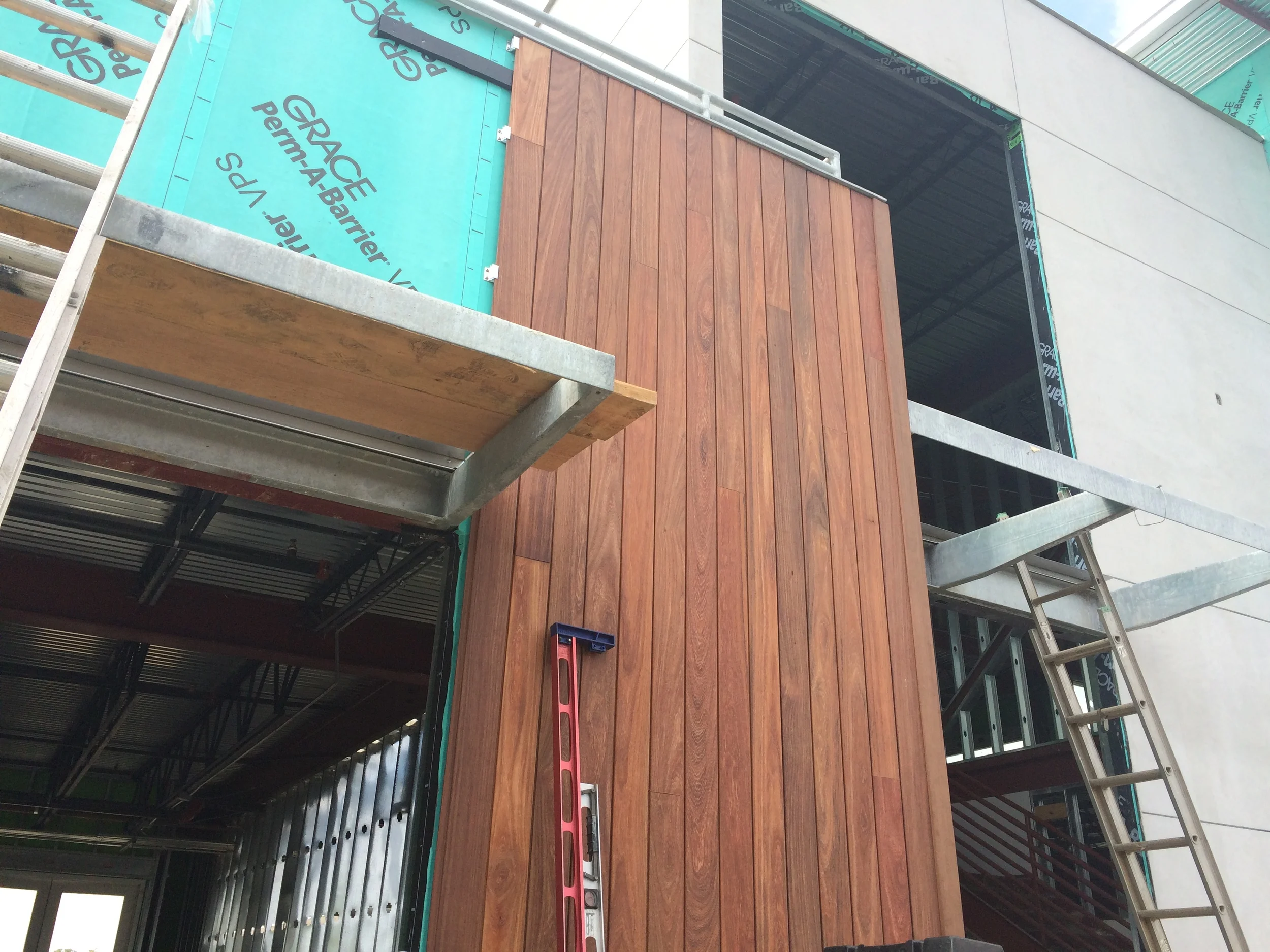 Installation of the wood rainscreen in progress