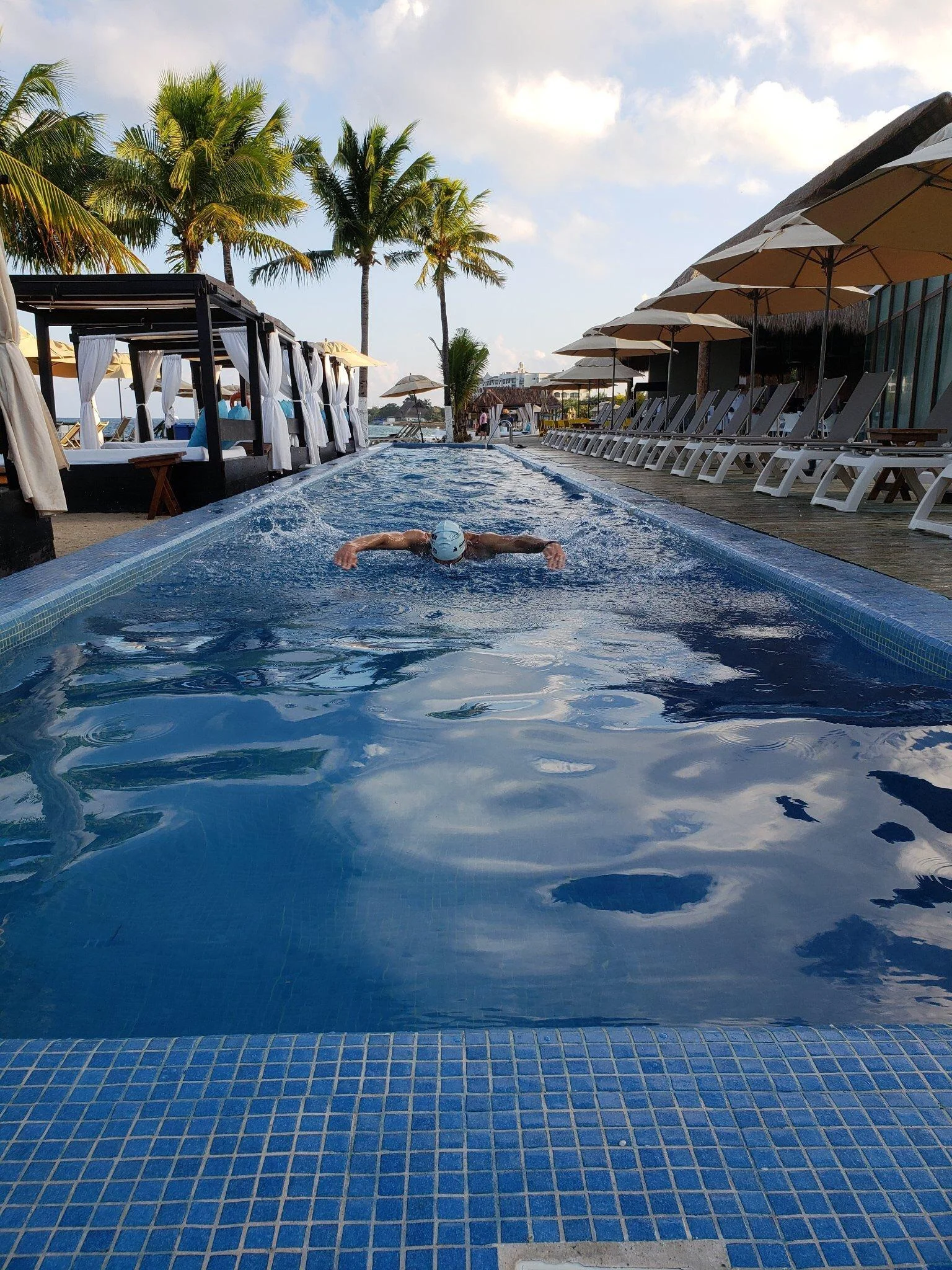 Swimming butterfly on tired legs in a hotel pool. All For The Gram.