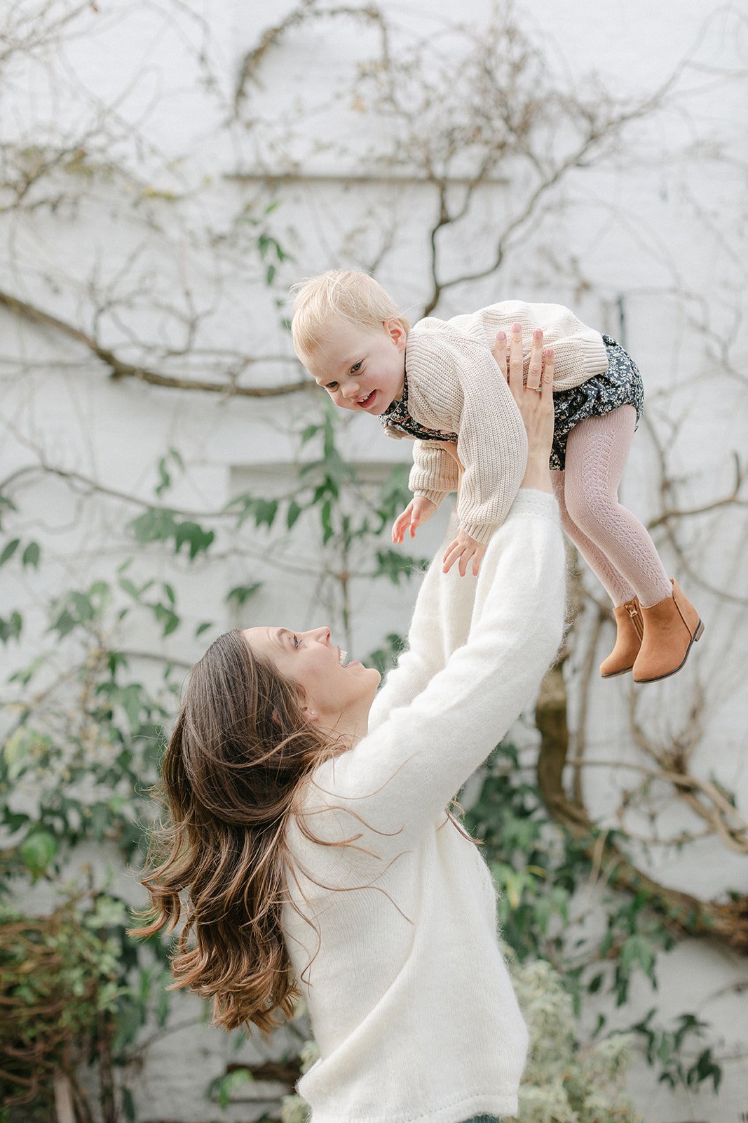  mother holding toddler in air at pembroke lodge richmond park photoshoot 