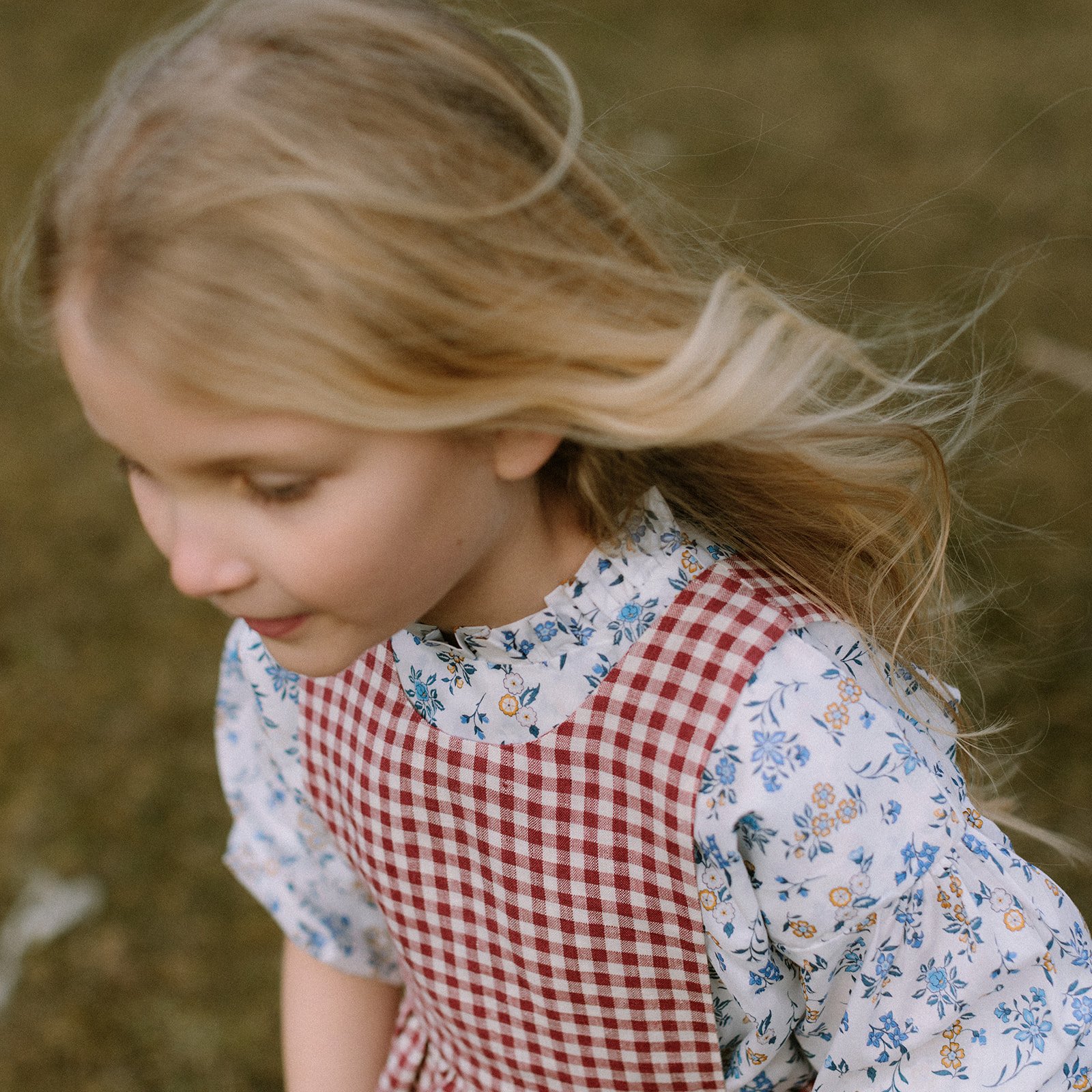  childrenswear fashion photographer girl in red linen gingham smocked dress 