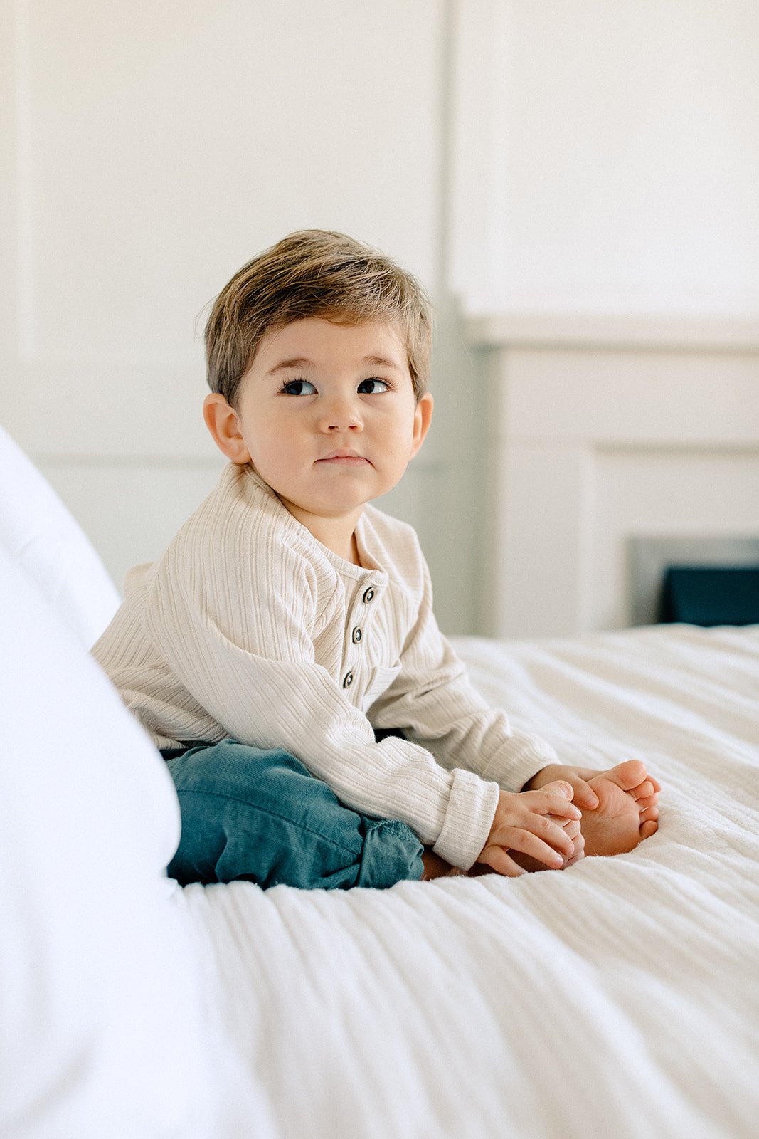  family photoshoot of toddler boy on bed in tunbridge wells 
