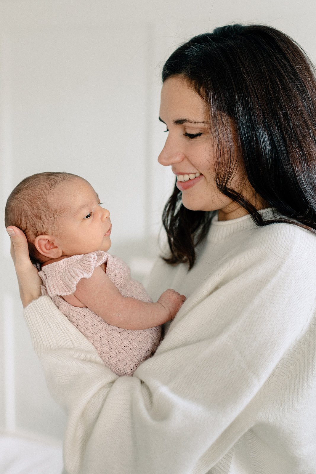  mum holdinh baby at newborn photographer shoot in tunbridge wells 
