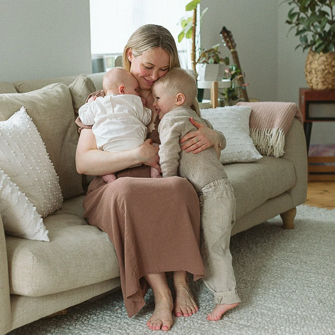 newborn-photographer-tunbridge-wells-mother-cuddling-children.jpg