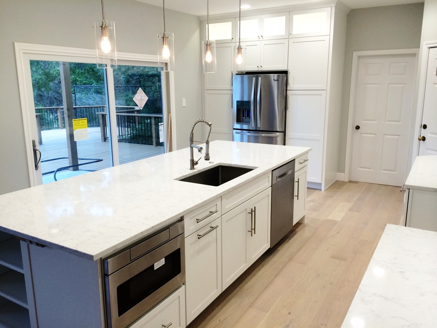  Beautiful new kitchen!&nbsp;Complete with white cabinets from UB Kitchens, quartz countertops, glass backsplash. There is extra storage space with the spacious island and full height cabinets. It is beautifully lit with under cabinet lighting as wel