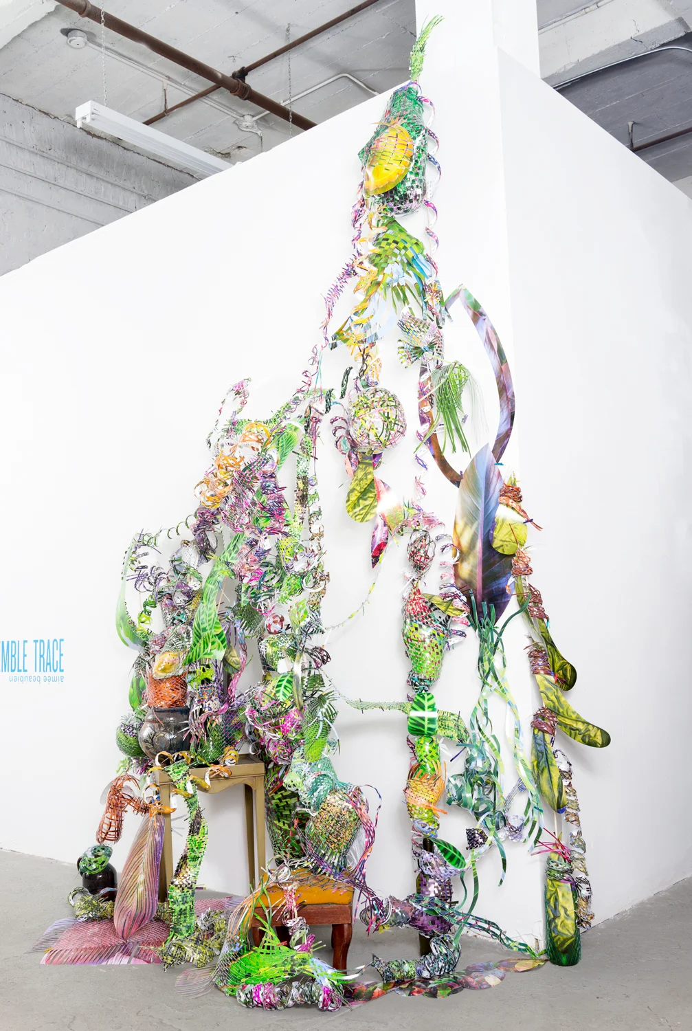   Chitter-burst-tangle-swell , 2015  cut-up inkjet prints, wooden dowels, ceramic bowl, glass bottles, ceramic jugs, needle point foot stool, wooden table, and miniature clothespins  dimensions variable     Twist-flip-tremble-trace , Johalla Projects