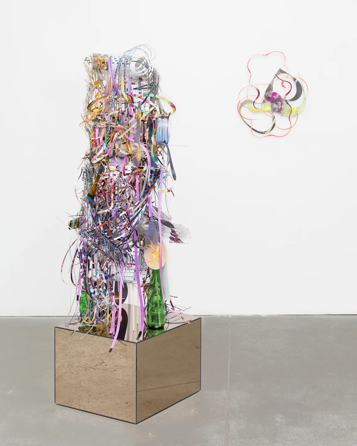  Sling-tether-wag-rhyme , 2014  cut-up pigment prints, wooden dowels,&nbsp;miniature clothespins, mirrored side table and glass bottles  49 x 18 x 16 inches  &nbsp;  on the wall:&nbsp;   Overlapping progression , 2013  cut-up pigment prints  21 x 17