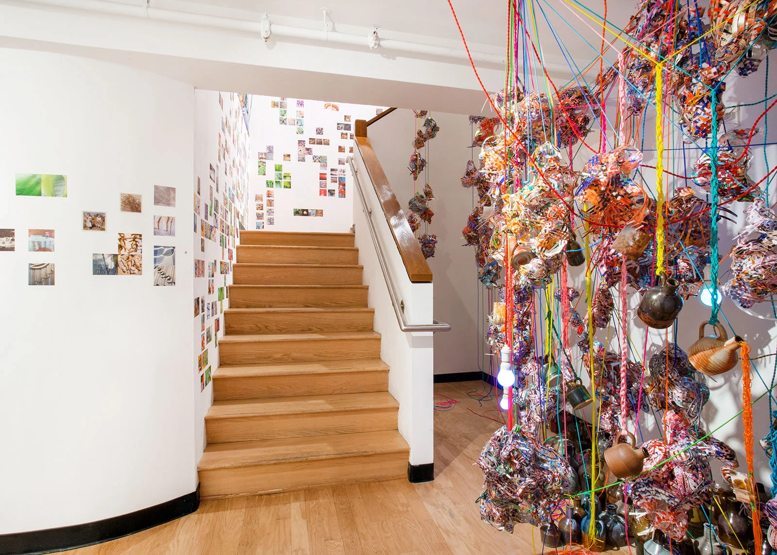   Collecting Within , 2016  cut-up inkjet prints, paracord, mason line, wooden dowels, miniature clothespins, whiskey jugs, party lights  dimensions variable   MoCP at 40 , Museum of Contemporary Photography, Chicago, IL 