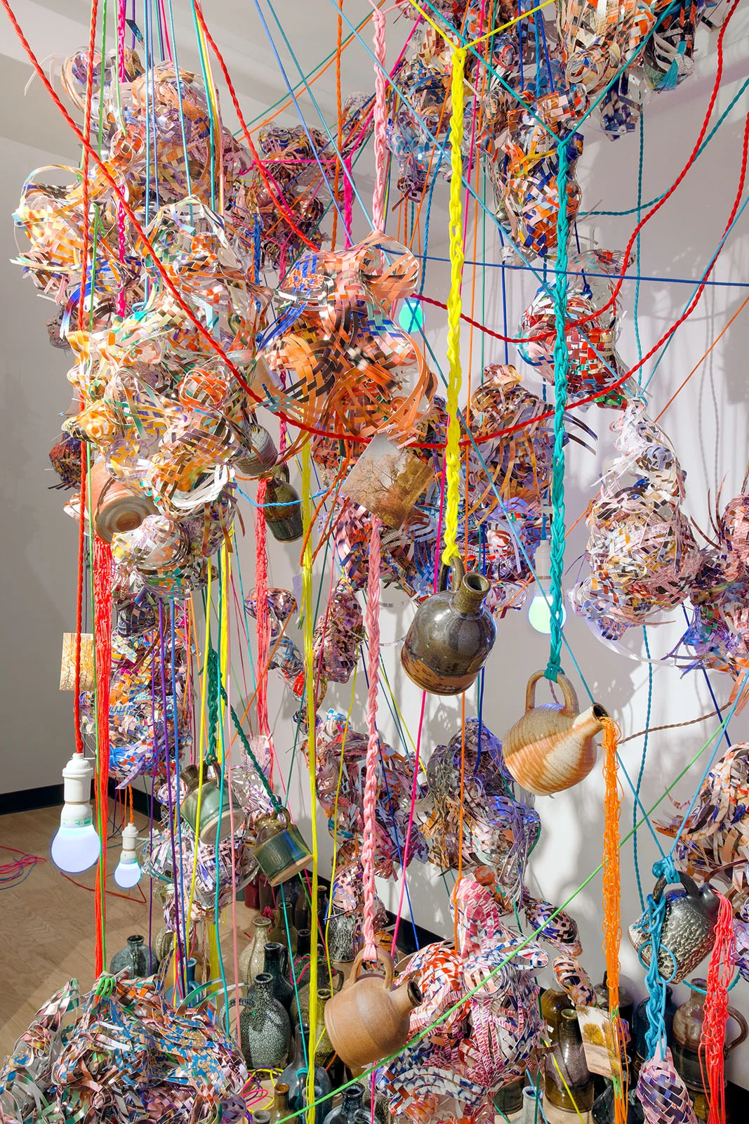   Collecting Within , 2016  cut-up inkjet prints, paracord, mason line, wooden dowels, miniature clothespins, whiskey jugs, party lights  dimensions variable   MoCP at 40 , Museum of Contemporary Photography, Chicago, IL 