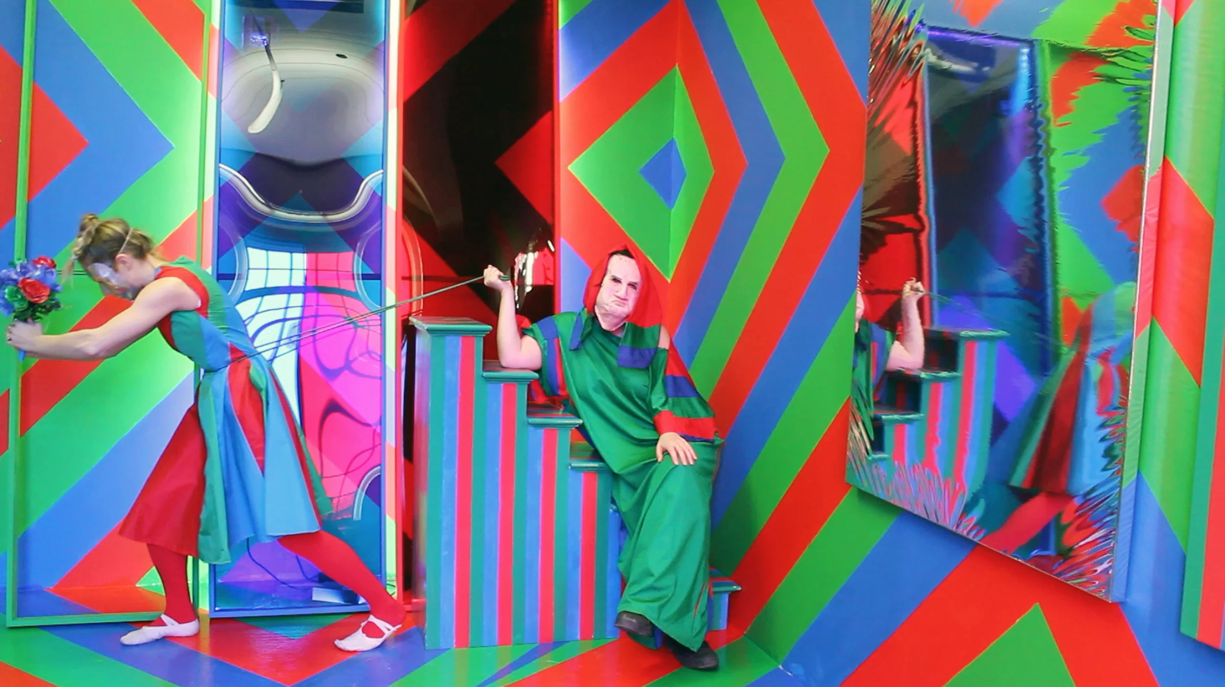 B. R. A. C. E., MASS MoCA documents an obstacle course/performance/installation created by artist Patricia Brace while in a residency at MASS MoCA in 2018. The video features Brace, with artists Vered Snear, Danielle Andress, Chris Williford, Elisabeth Smolarz, and Hyo Jin Yoo, performing within an immersive, hard-edge, abstract, red, green, and blue environment. Wearing corresponding red, green, and blue B. R. A. C. E. costumes, in each act, performers activate the space with collaborative and improvisational feminist sketches. Bifurcated Radical Anarchist Cultural Enterprise or B. R. A. C. E. is a performance group of 1-5 women and LGBTQIA performers established by artist Patricia Brace in 2016. Since then B. R. A. C. E. has performed at Rutgers University, IF Museum Academy, Tête Berlin and MASS MoCA. Using hybridized forms of athletics, dance, product design, and analogue and digital technologies, B. R. A. C. E. seeks to expose and ratify injustices that women and LGBQTIA identifying people experience as a trickle down from governmental policies. When laws affect personal liberties and expressions of identity B. R. A. C. E. asks “what is truth in a political system that lies and how do we occupy that space?” Photo credit: Patricia Brace and Vered Snear