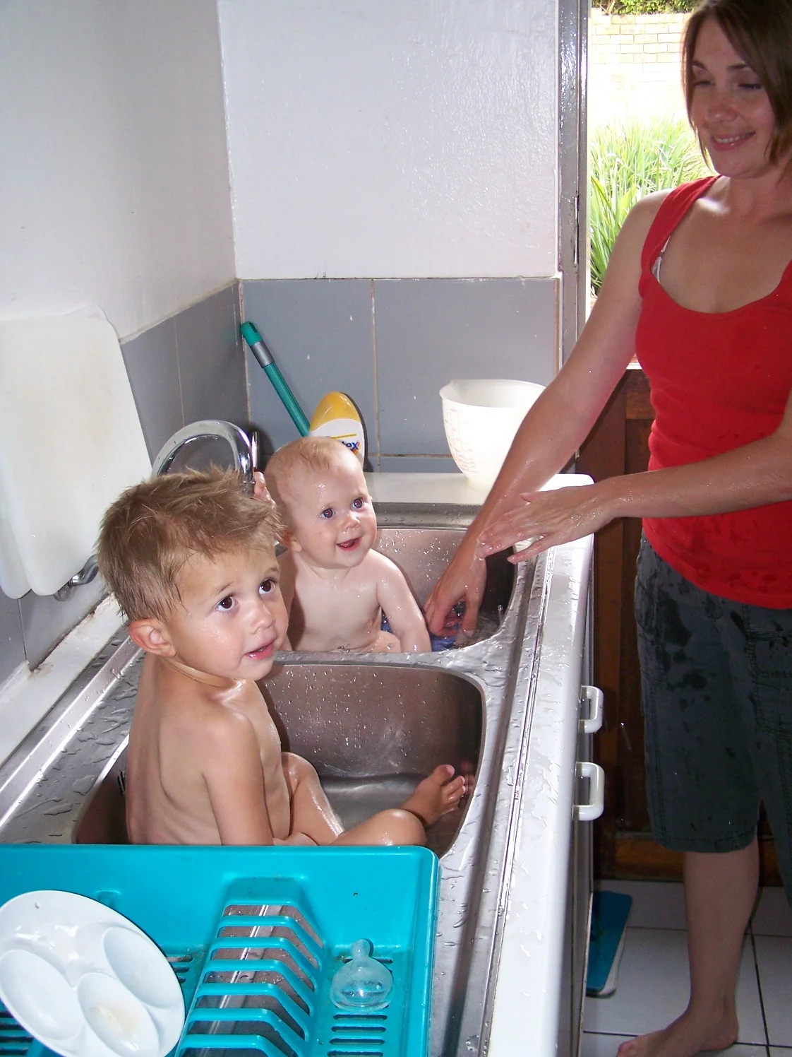 And then we had kids. This was taken in Ouma's (Rob's mom's) scullery. The scullery is a wonderful room off of the kitchen where you hide the sink and the washer and dryer. Check out the dutch door in the background.