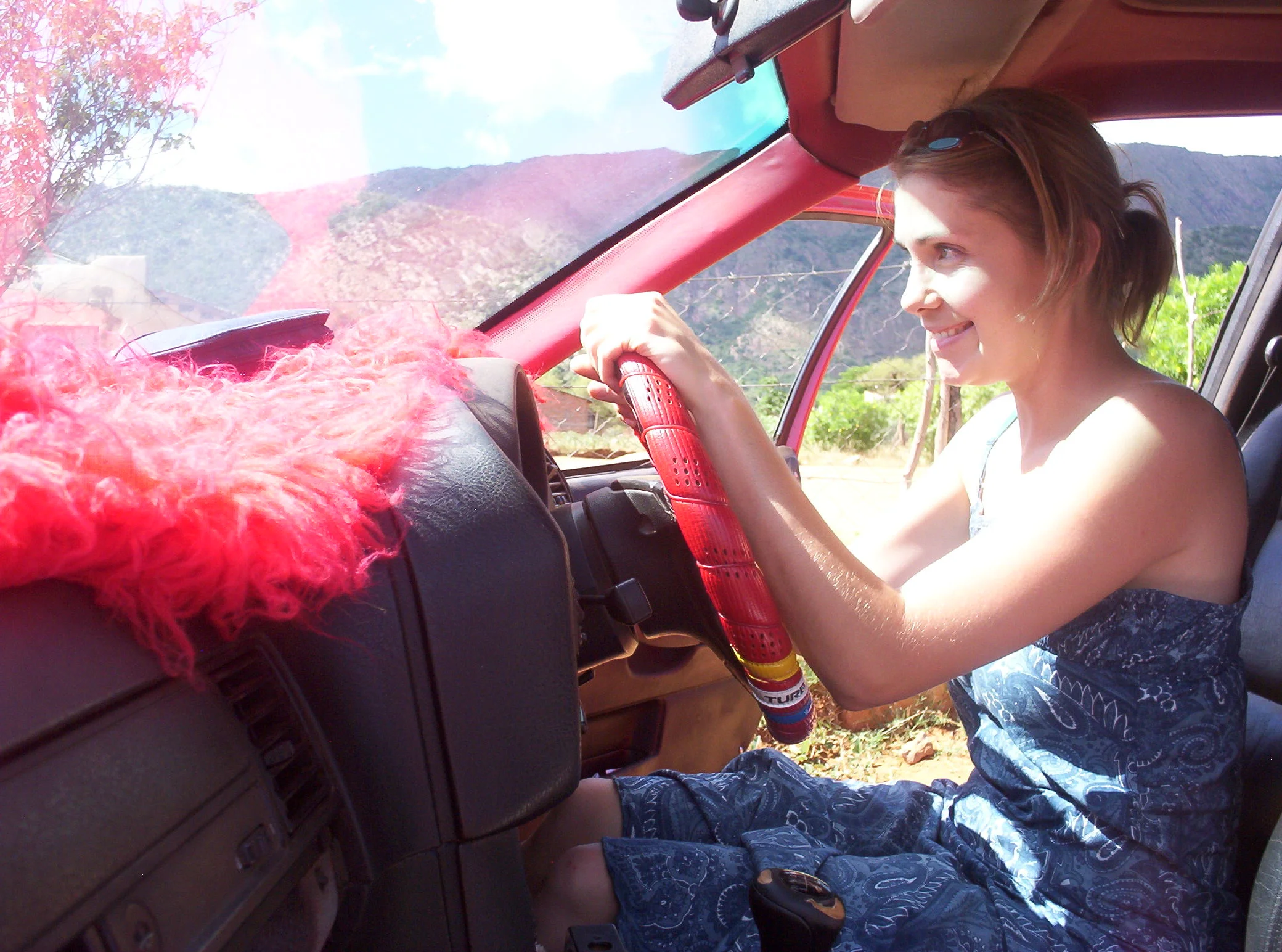 The Peace Corps years. As Peace Corps volunteers we weren't allowed to drive, however the owner of this fine ride had terrible cataracts and we were on a tedious drive so he asked me to. And yes this is a manual BMW with red fur and a red wheel. : )