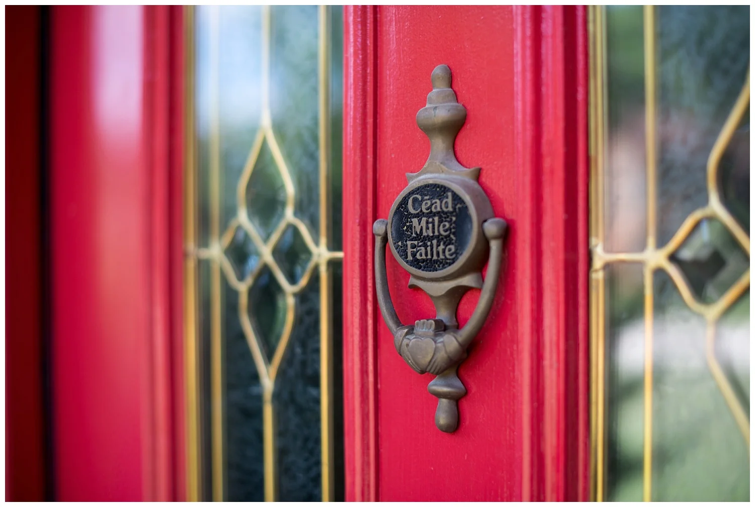 Even though Catherine grew up in England and Ireland, she didn't put the Claddagh ring - which is a traditional Irish symbol of love, loyalty and friendship - on her front door. The previous owners of the home were proud of their Irish ancestry and they hung it there. Catherine did paint the door red. "Cead Mille Failte" means 'one hundred thousand welcomes'. 